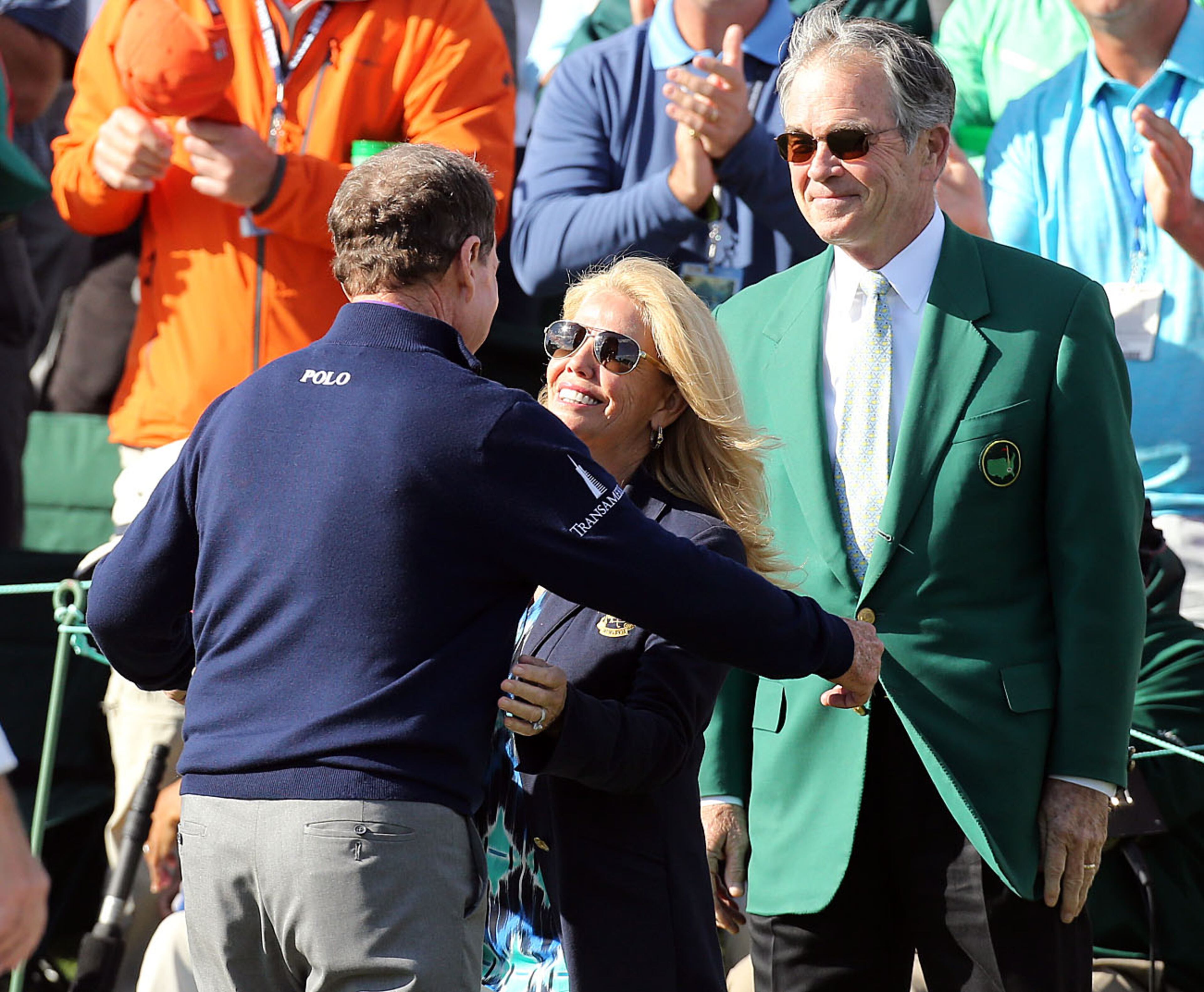 Tom Watson gets a hug from his wife Hilary, as Billy Payne, Masters chairman looks on, after Watson finished his round on the 18th green during his final Masters appearance during the second round of the 80th Masters at the Augusta National Golf Club, Friday, April 8, 2016. Curtis Compton/ccompton@ajc.com
