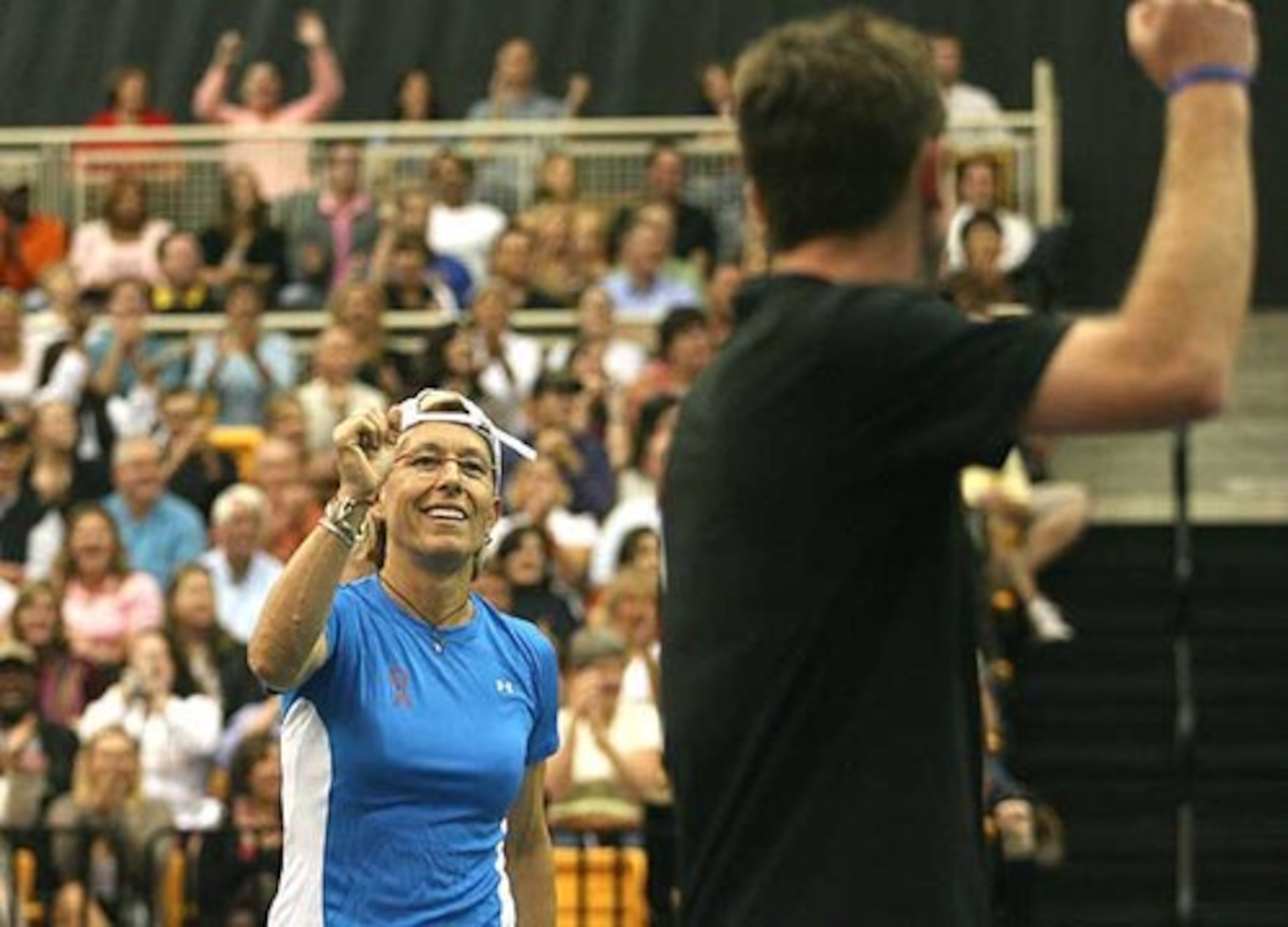 Martina Navratilova celebrates winning a point with partner Jesse Levine during a mixed doubles match af the Advanta WTT Smash Hits tennis event at Kennesaw State University.