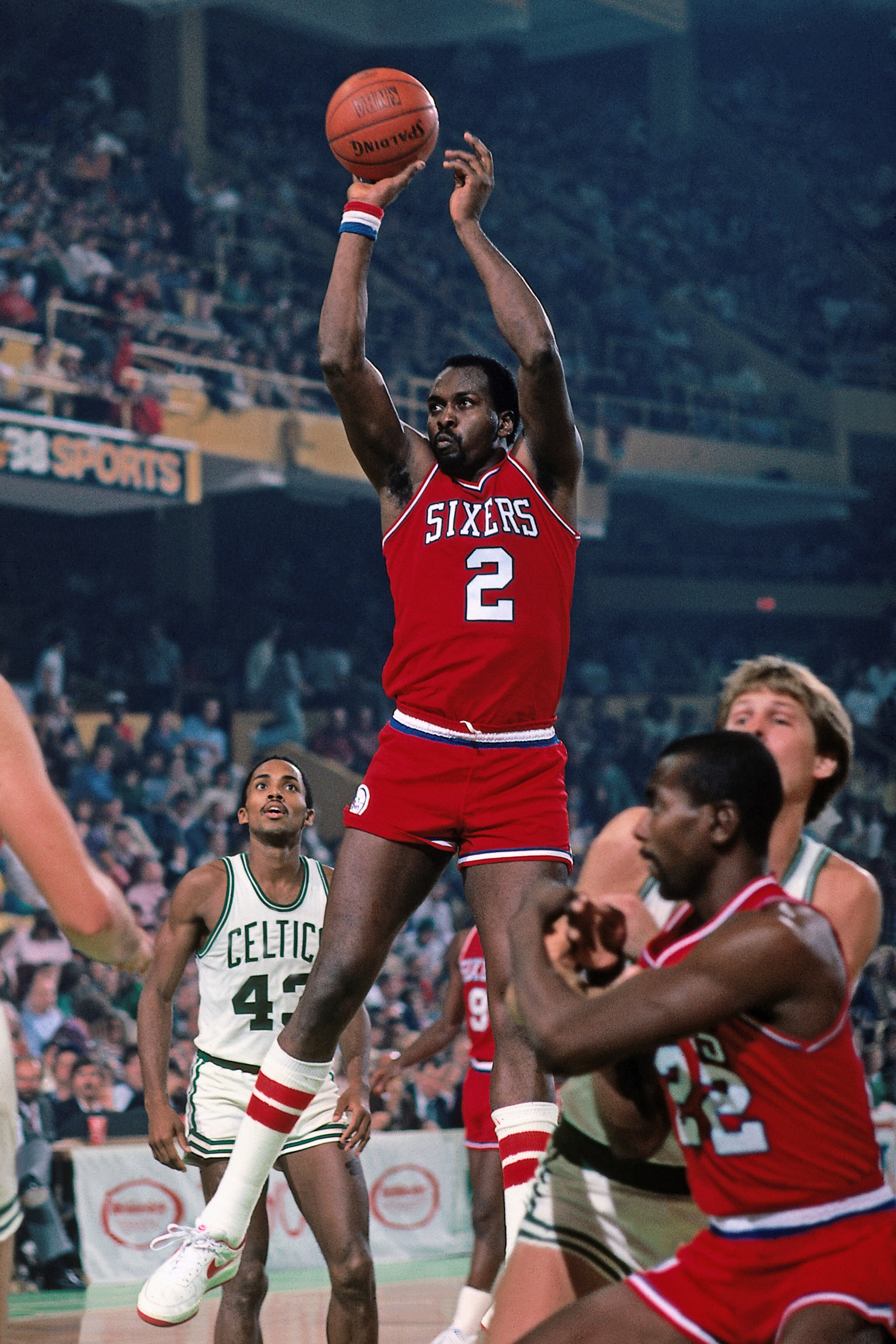 BOSTON, MA - 1984: Moses Malone #2 of the Philadelphia 76ers shoots against the Boston Celtics during a game played circa 1984 at the Boston Garden in Boston, Massachussets. NOTE TO USER: User expressly acknowledges and agrees that, by downloading and or using this photograph, User is consenting to the terms and conditions of the Getty Images License Agreement. Mandatory Copyright Notice: Copyright 1984 NBAE (Photo by Dick Raphael/NBAE via Getty Images)