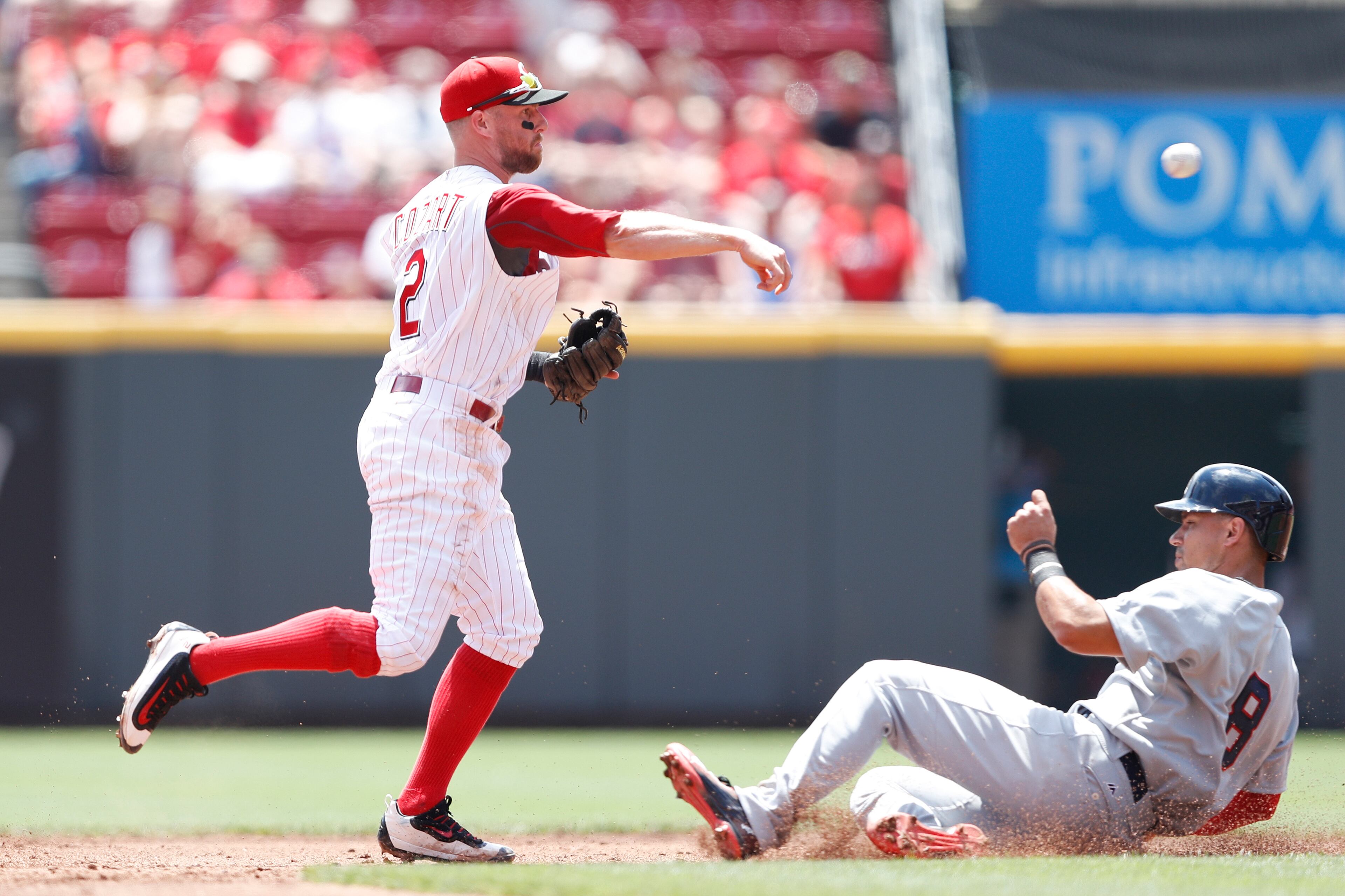 CINCINNATI, OH - JULY 20: Zack Cozart #2 of the Cincinnati Reds turns a double play ahead of the slide at second base by Jace Peterson #8 of the Atlanta Braves in the third inning at Great American Ball Park on July 20, 2016 in Cincinnati, Ohio. (Photo by Joe Robbins/Getty Images)