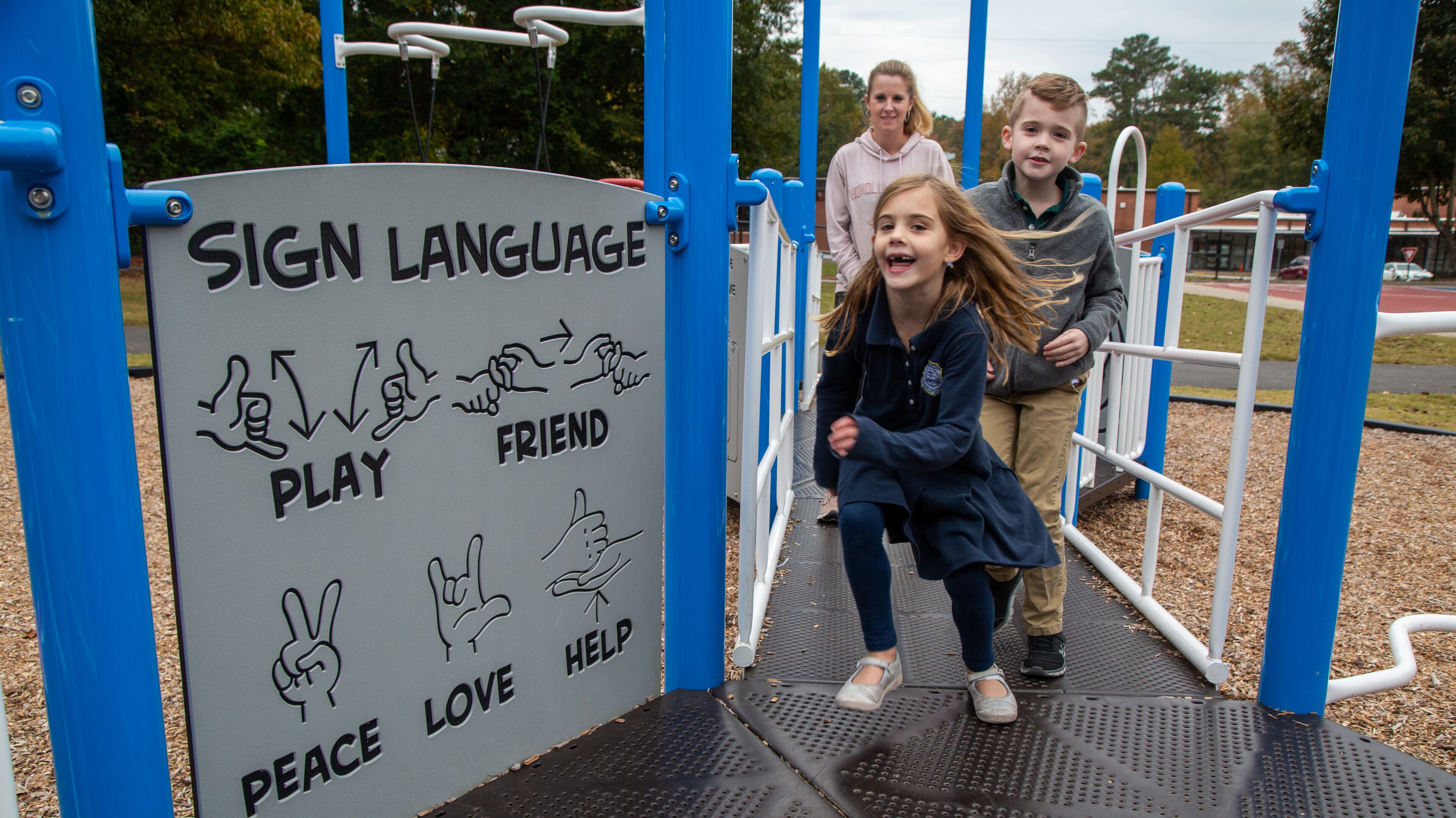 Blakely Davis (age 6) runs along the the all-inclusive playground followed by her brother Cameron (8) and mother Dana at Alpharetta Elementary School. PHIL SKINNER FOR THE ATLANTA JOURNAL-CONSTITUTION.
