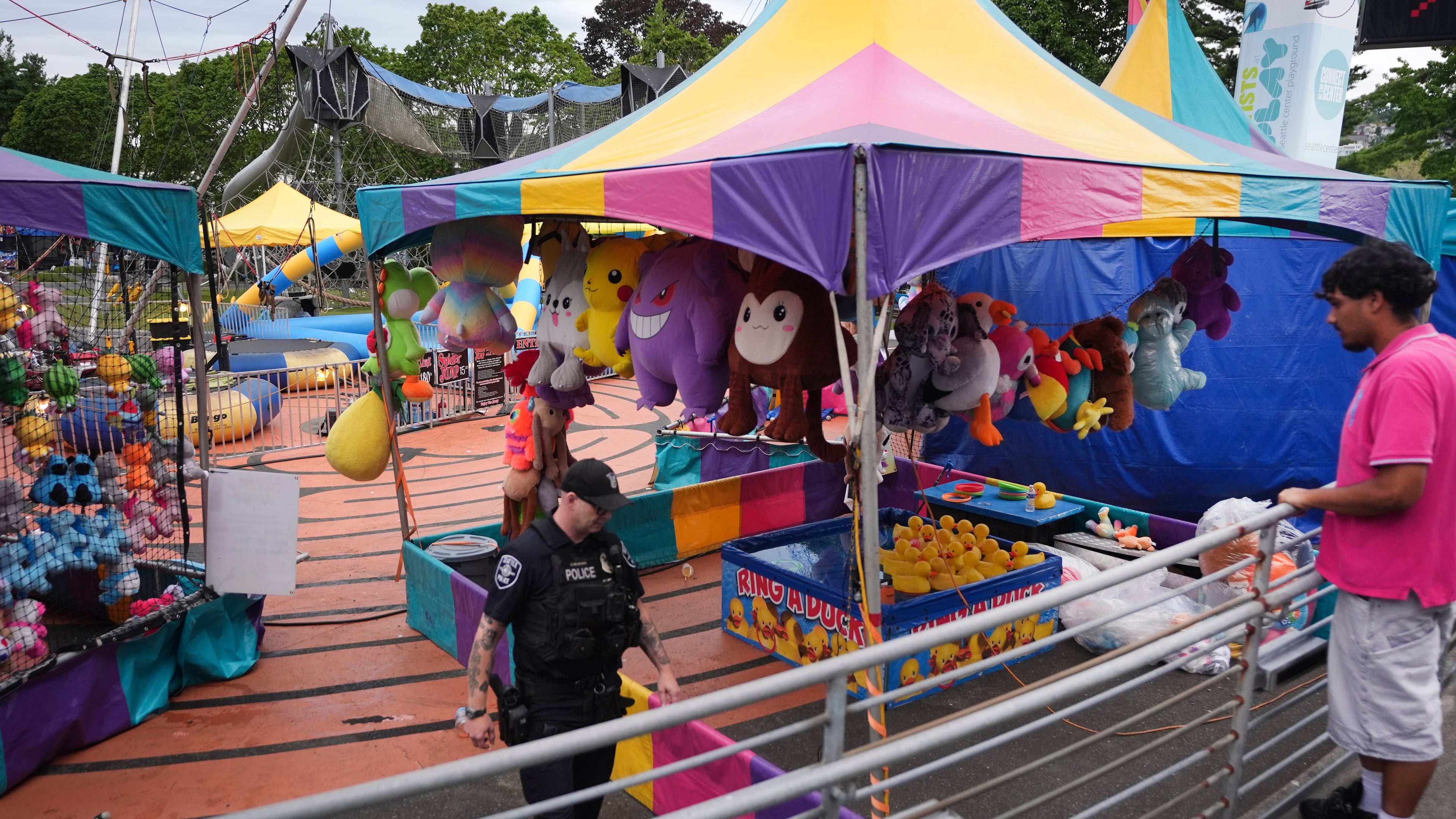 A police officer responds after a shooting at Seattle Center during the Bite of Seattle food festival Sunday, July 26, 2026, in Seattle, Wash. (AP Photo/Lindsey Wasson)