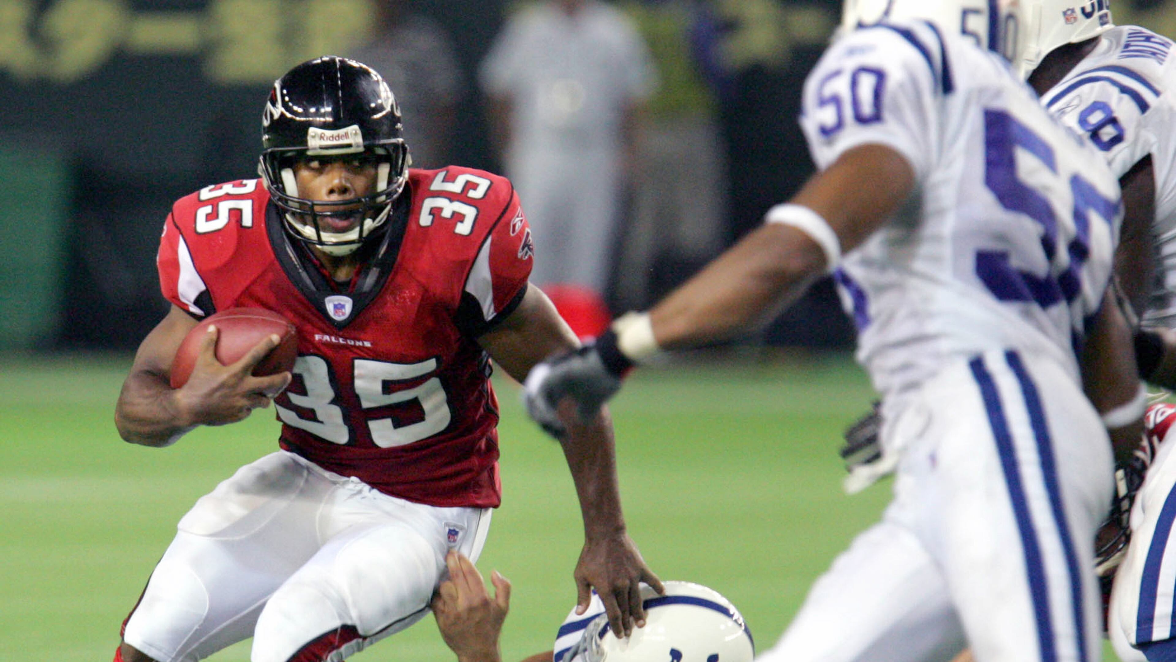 Atlanta Falcons running back Jason Wright, left, is tackled by Indianapolis Colts defensive end Josh Mallard in the second quarter of their NFL's exhibition season game American Bowl at Tokyo Dome Saturday, Aug. 6, 2005. (AP Photo/Koji Sasahara)