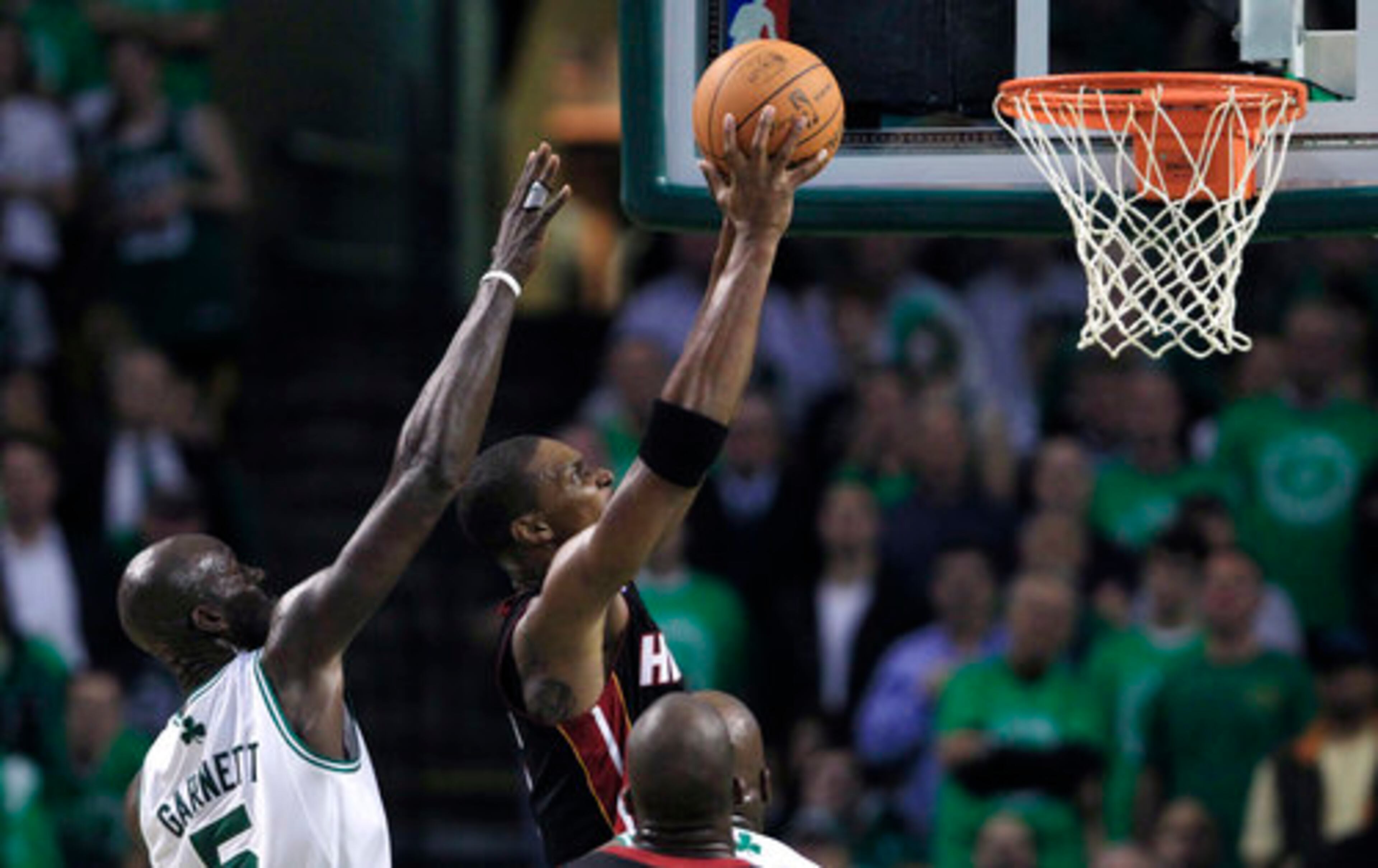 Bosh goes up for a dunk as Garnett tries to defend from behind.