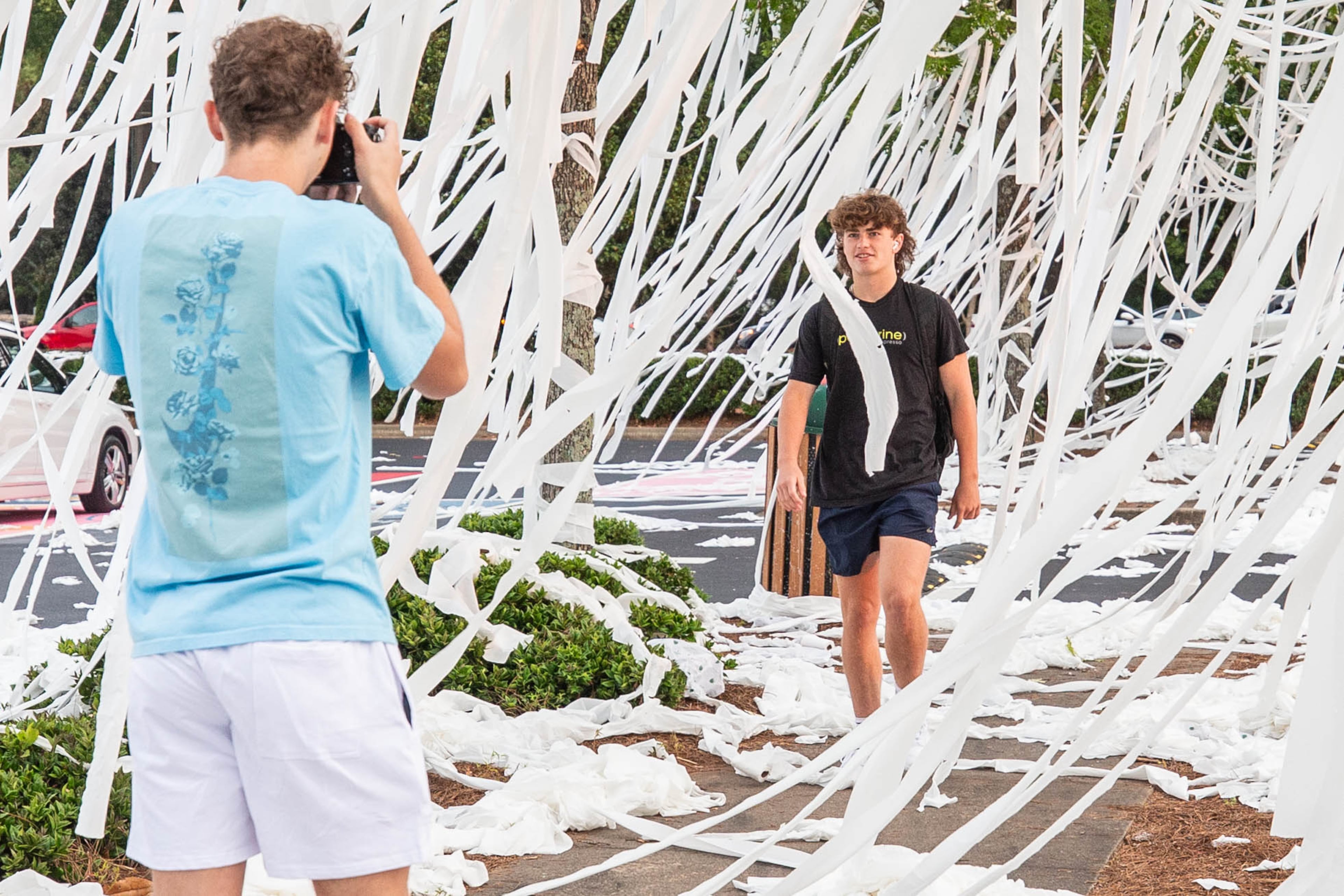 Students document the tradition for the yearbook before going to their first day of classes in Marietta on Wednesday, August 2, 2023. Following with tradition, the new seniors of Marietta High School TPed their school the night before the first day. (Katelyn Myrick/katelyn.myrick@ajc.com)