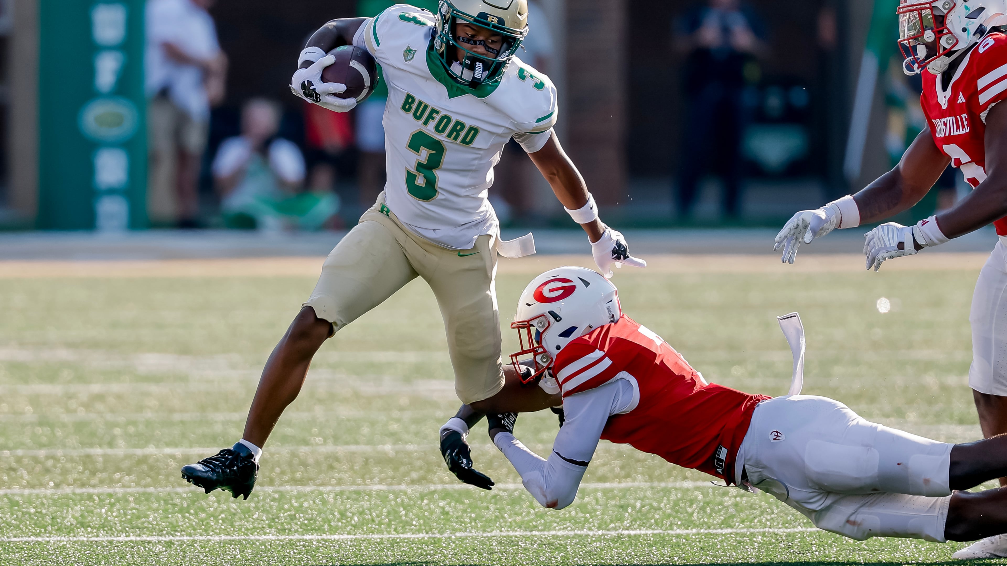 Buford's Ashton Thomas is tackled by Gainesville's Jeremiah Proctor during the first half of a high school football game between Buford and Gainesville, Saturday, Aug. 22, 2026, in Buford, Ga. (Erik S. Lesser for the AJC)
