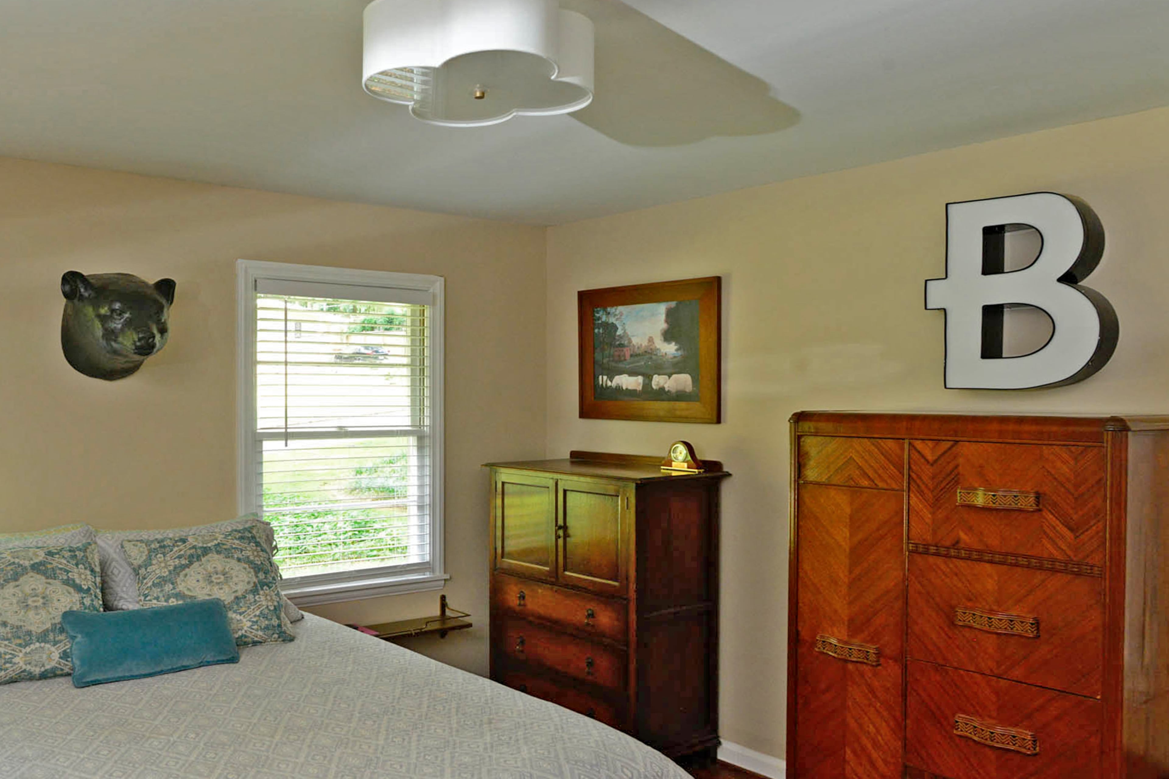 The master bedroom furniture was acquired in a number of ways. One of the dressers is from a dance studio estate sale, while another dresser is a family antique and a nightstand is an old typewriter table.