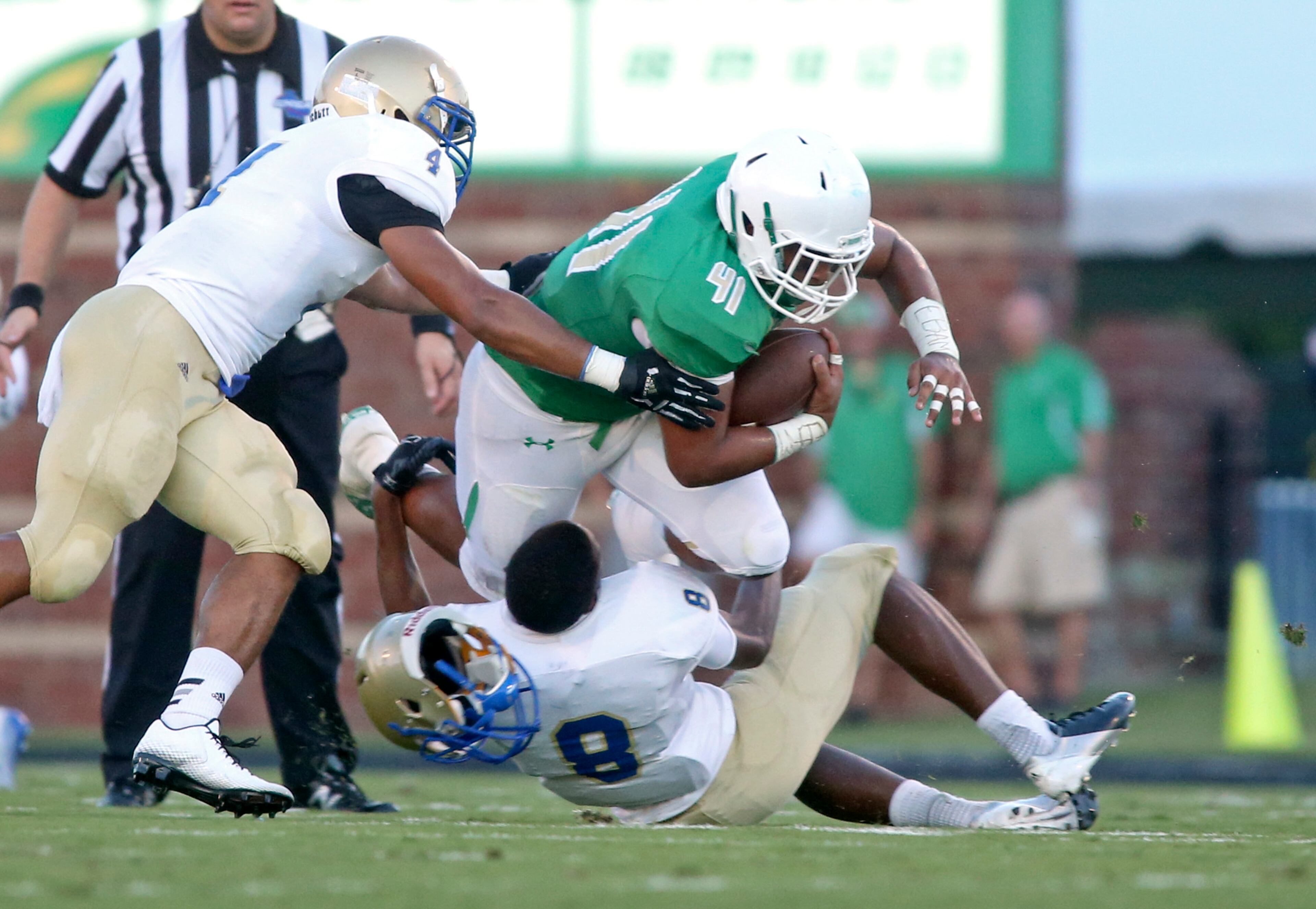 Buford fullback Jordan Perlotte (41) catches a pass for a first down as McEachern defensive back Bryan Okeh (8) looses his helmet on the tackle in the first half of their game Friday in Buford, Ga., Sept. 5, 2014. JASON GETZ / SPECIAL