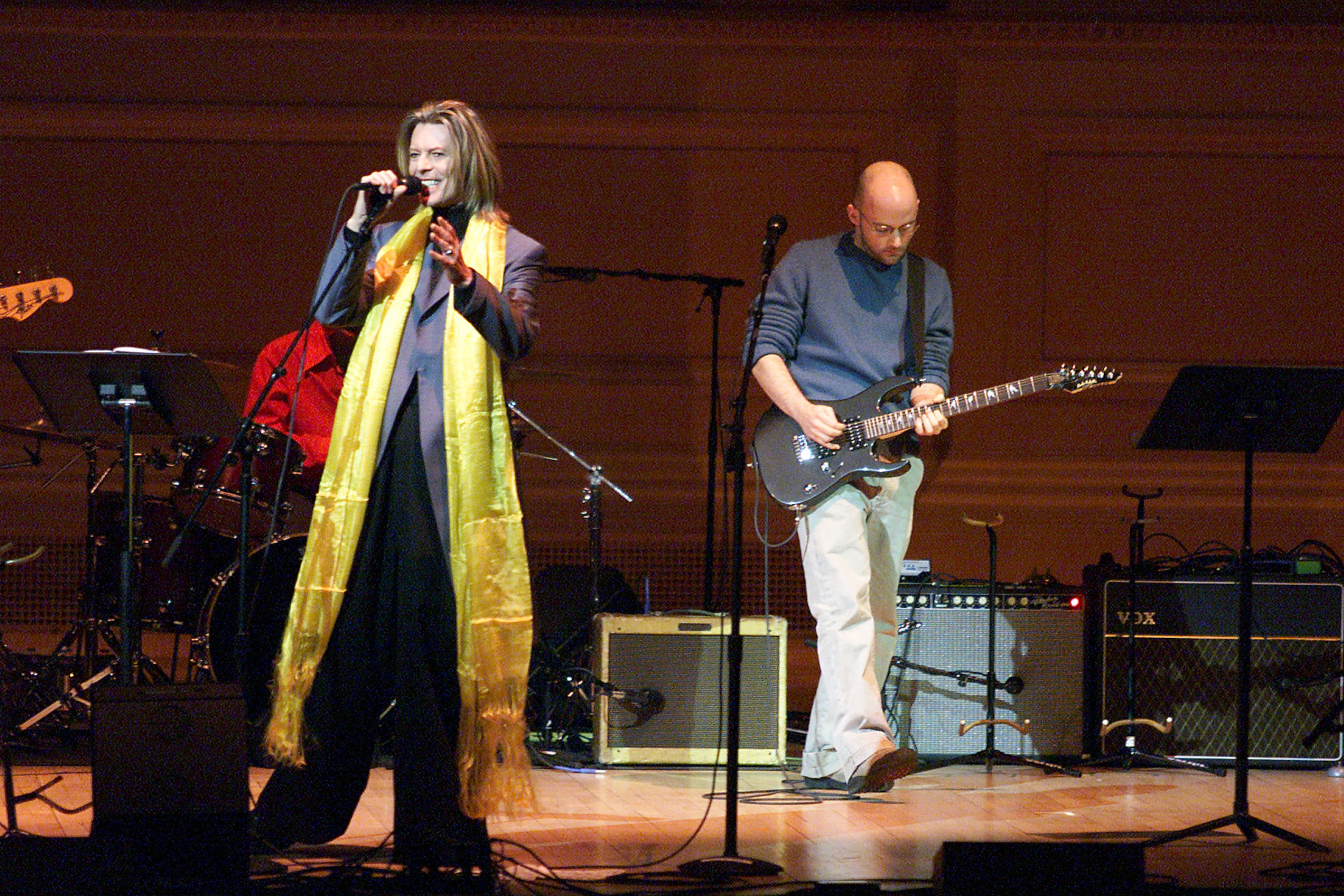 David Bowie and Moby on stage performing during the Tibet House Benefit Concert 2001 with artistic director Philip Glass, Dana Bryant, Emmylou Harris, Patti Smith, David Bowie, Nawang Khechog, Natalie Merchant, Moby, Rahat Nusrat Fateh Ali Khan and the Drepung Gomang Tibetan Monks at Carnegie Hall in New York City, New York on Monday February 26, 2001.