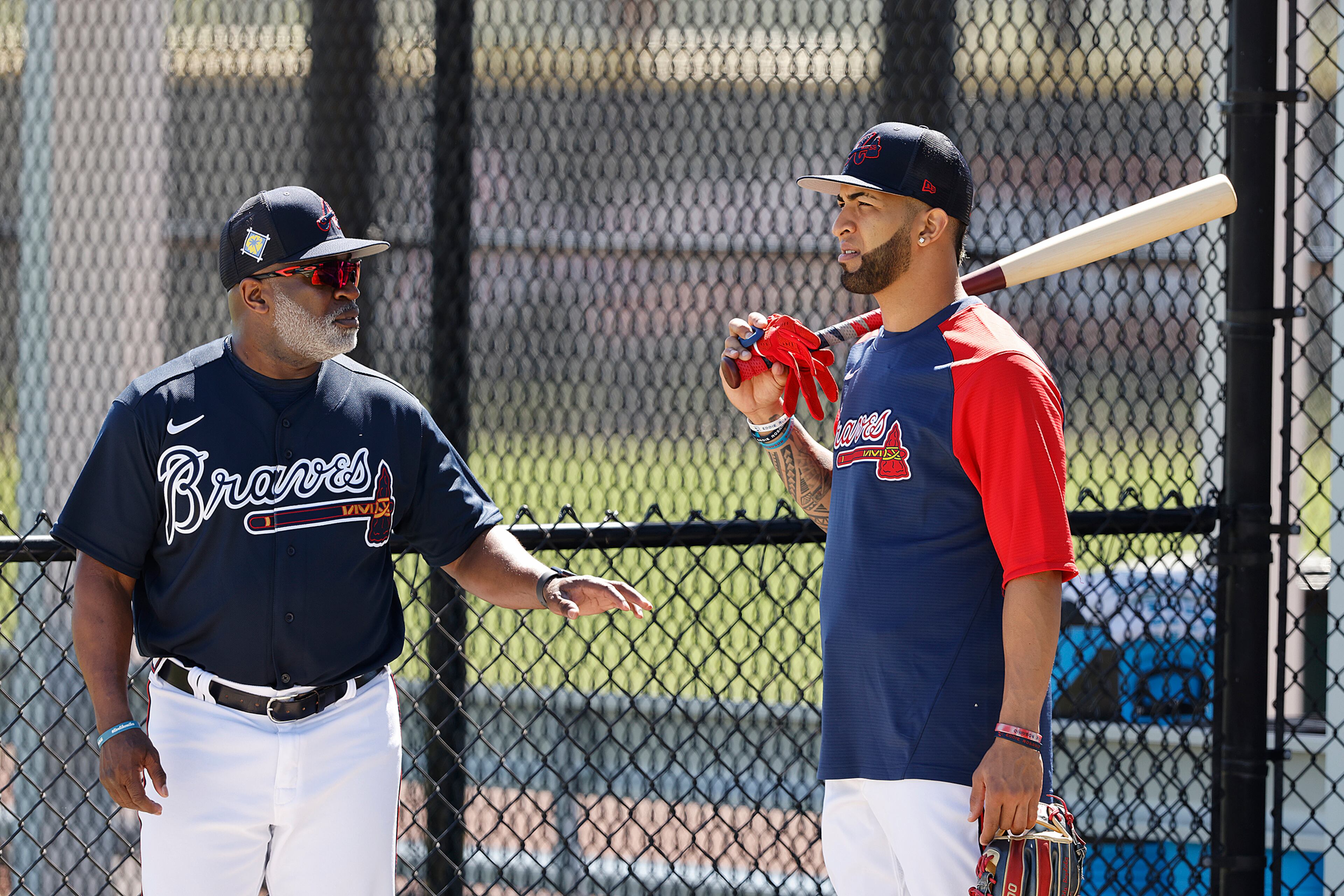 Braves outfielder Eddie Rosario confers with first base coach Eric Young. “Curtis Compton / Curtis.Compton@ajc.com”
