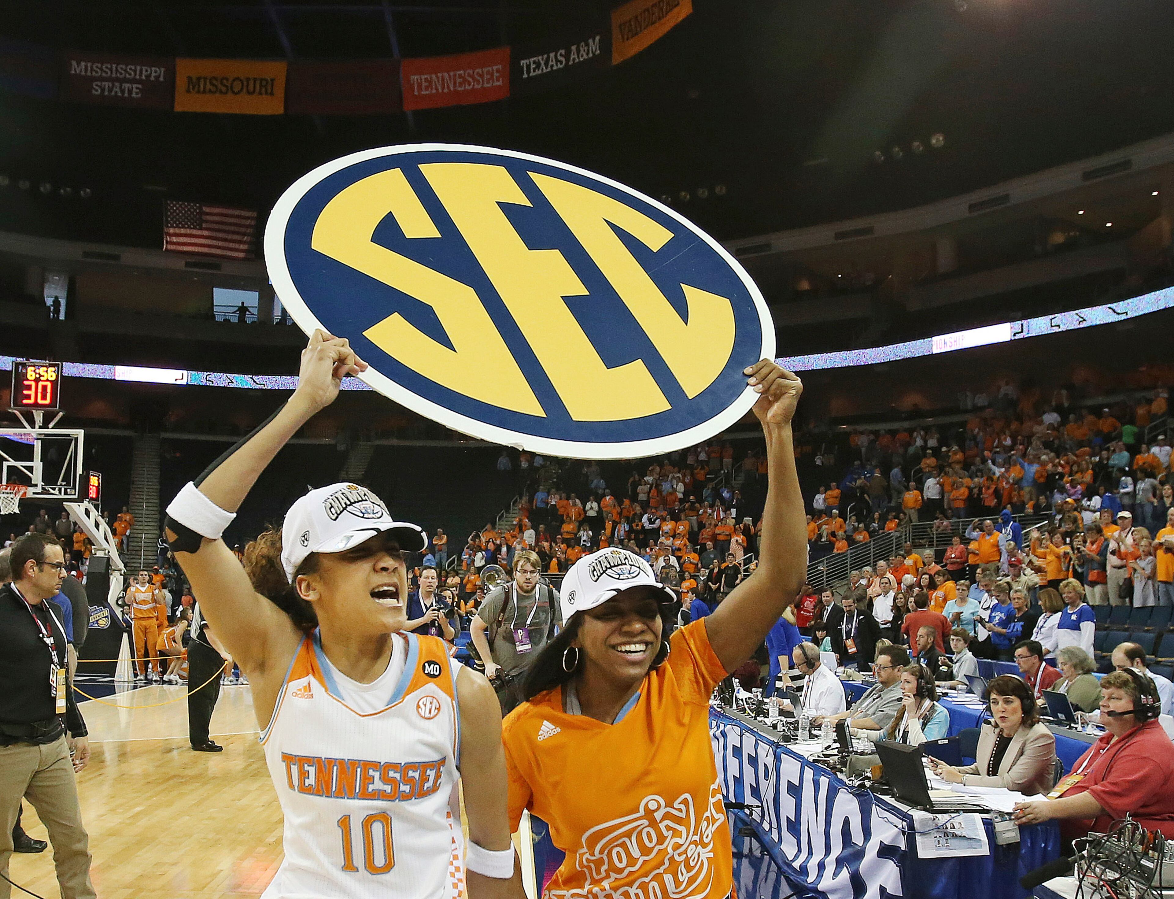 Tennessee guard Meighan Simmons (10) and injured teammate guard Ariel Massengale, right, celebrate after defeating Kentucky 71-70 in an NCAA college basketball game in the finals of the Southeastern Conference women's basketball tournament Sunday, March 9, 2014, in Duluth, Ga. (AP Photo/Jason Getz)