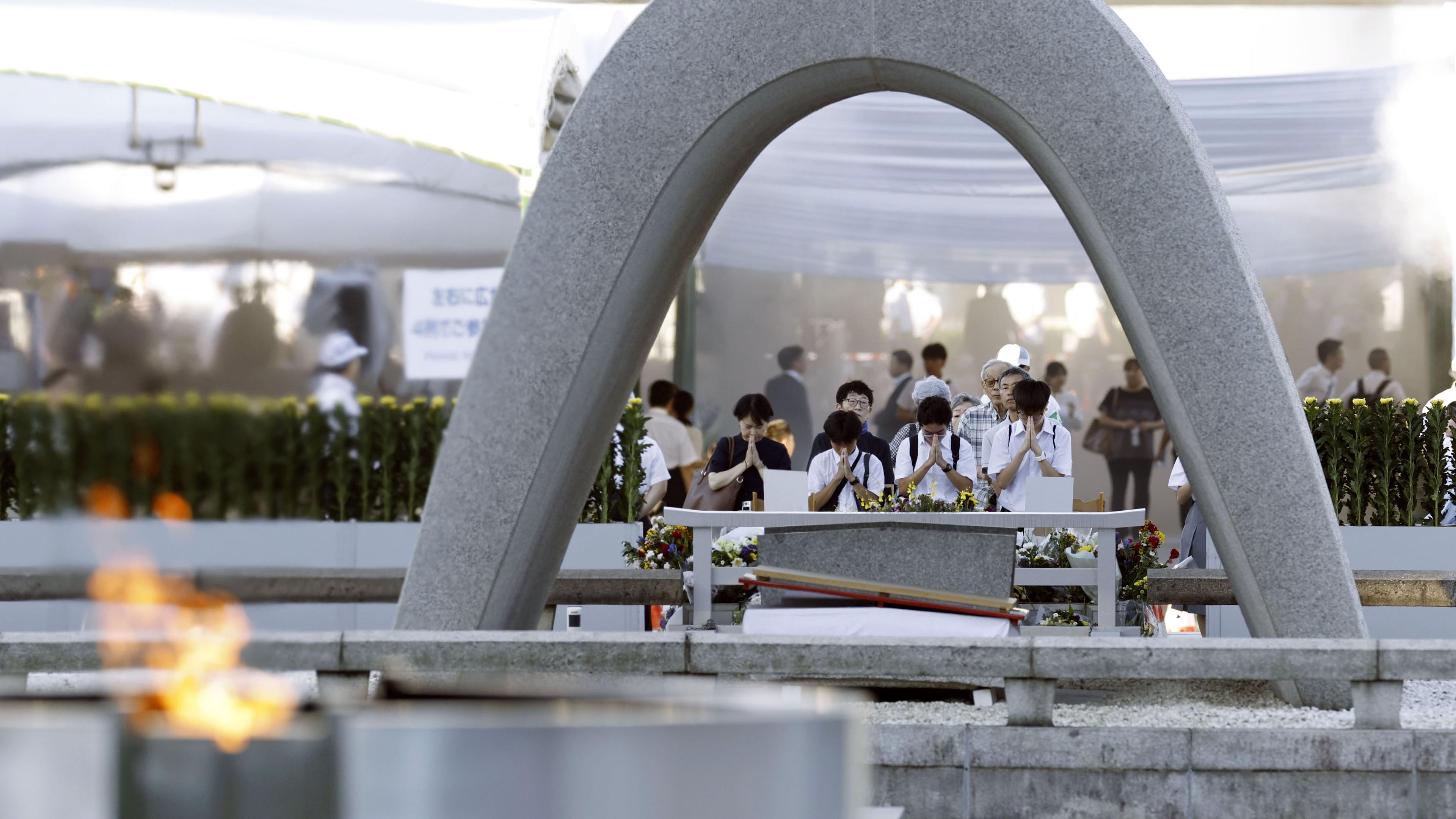 Visitors pray in front of the cenotaph dedicated to the victims of the atomic bombing ahead of a ceremony to mark the anniversary of the bombing at the Hiroshima Peace Memorial Park in Hiroshima, western Japan Thursday, Aug. 6, 2026. (Mizuki Sakai/Kyodo News via AP)