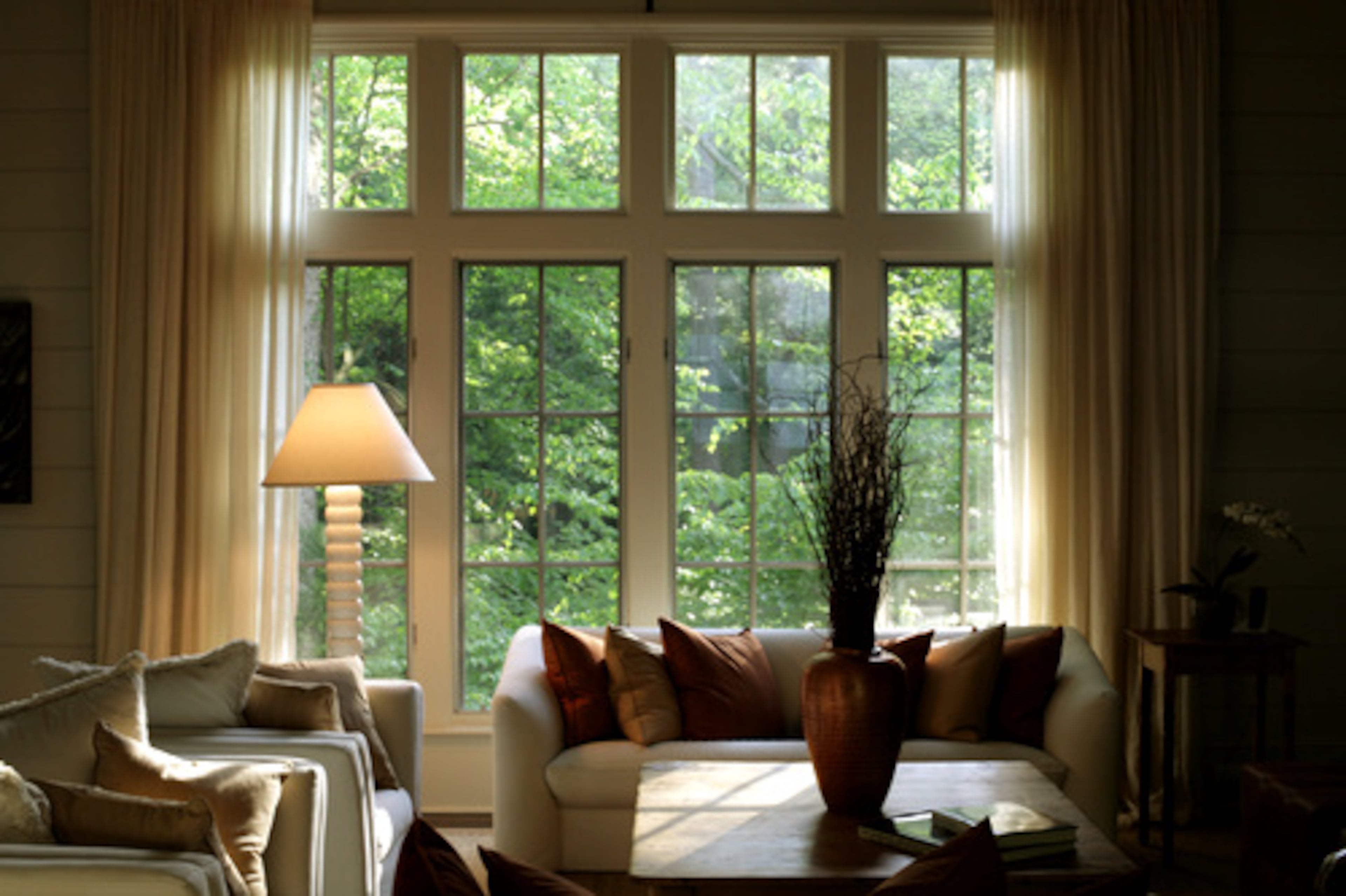 The keeping room's muted tones allow the beauty of the surrounding forest to add a splash of brightness through the windows.