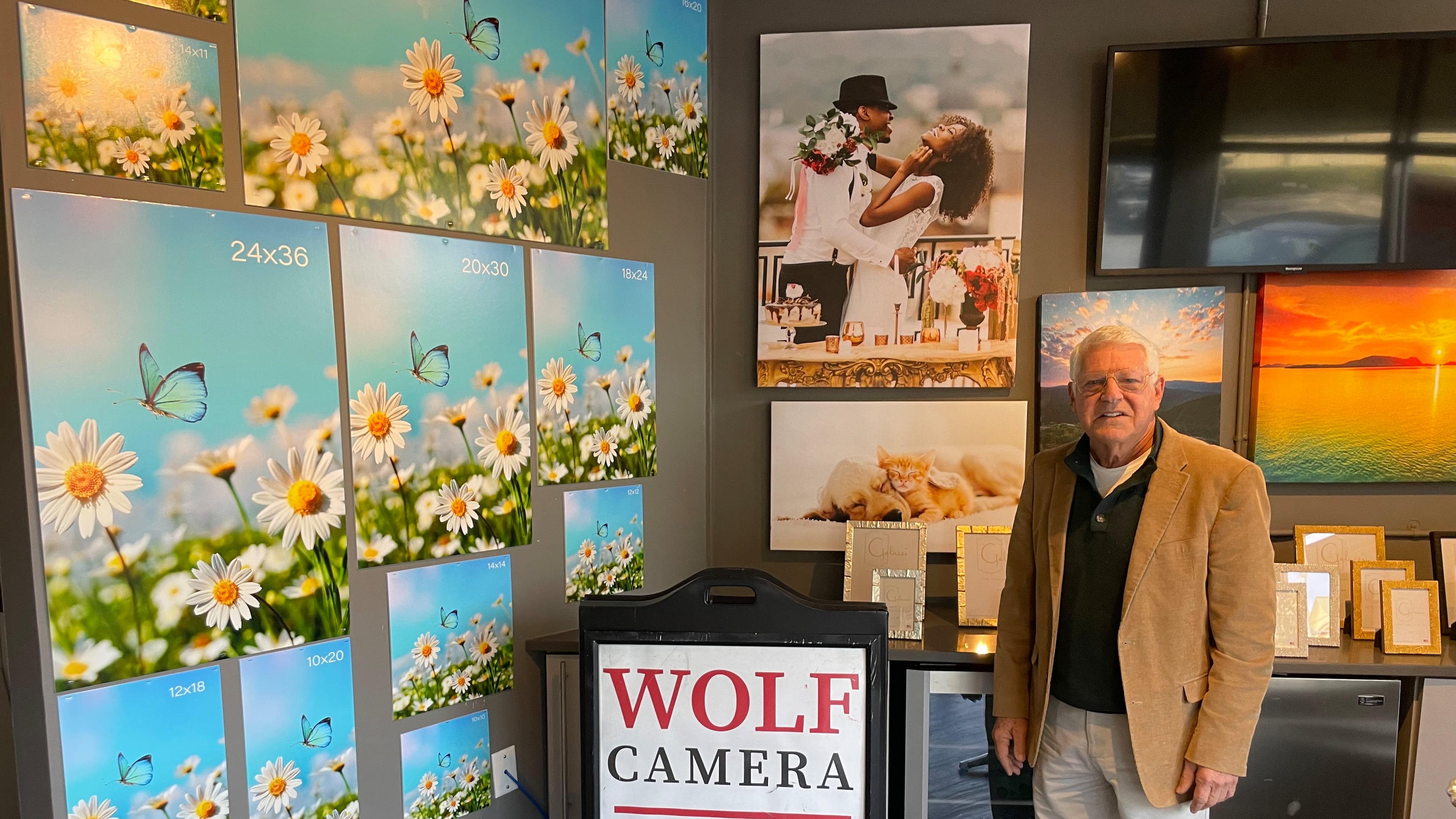 The namesake of Chuck Wolf's Photo Design Bar stands inside inside the entrance of his lone store in Buckhead. Wolf once reigned over an empire of 700-plus photo shops before the business changed.