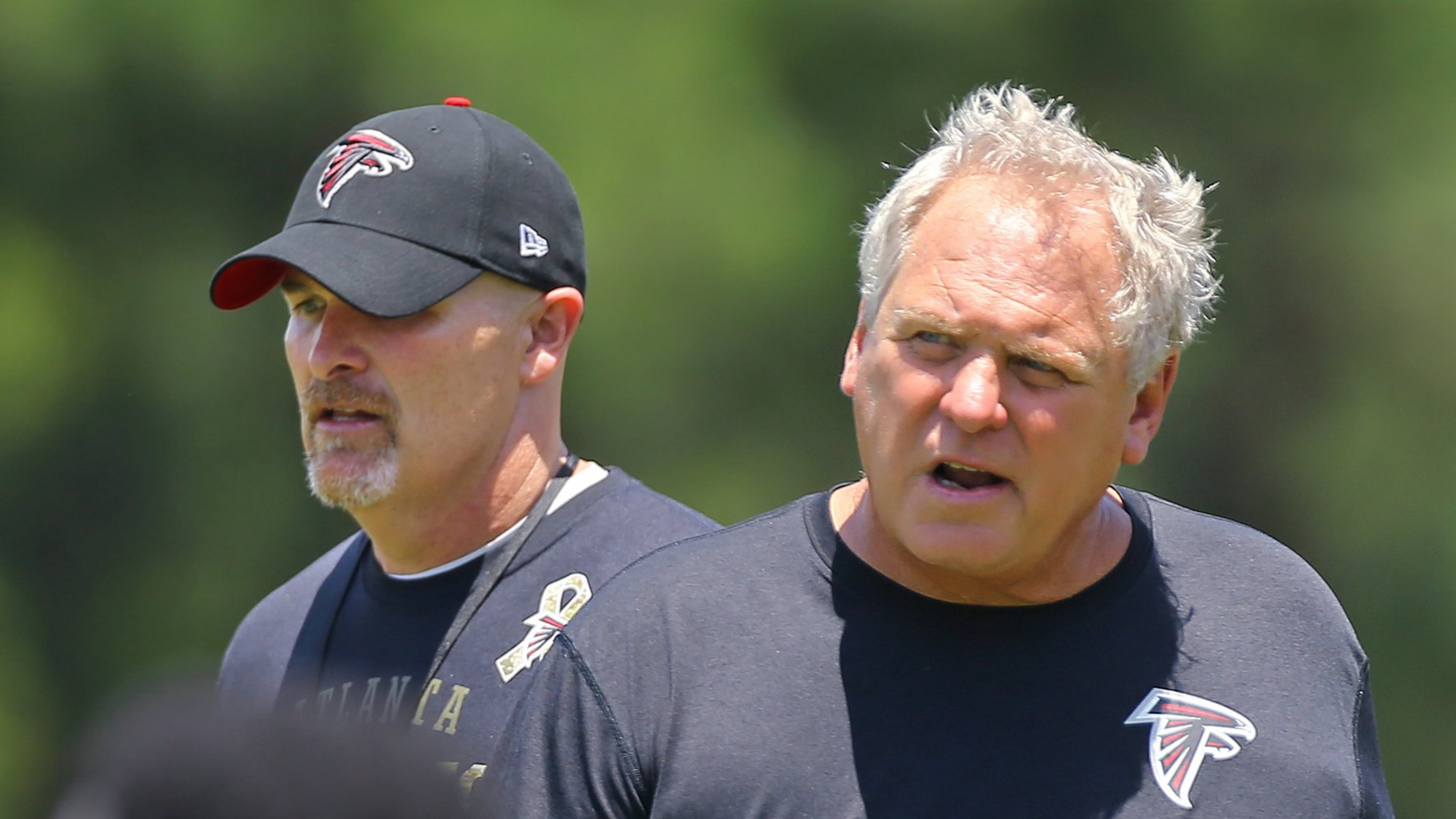 061615 FLOWERY BRANCH: Falcons head coach Dan Quinn (left) and defensive coordinator Richard Smith proul the field at practice while the team opens a 3 day mini-camp open to the public on Tuesday, June 16, 2015, in Flowery Branch. Curtis Compton / ccompton@ajc.com