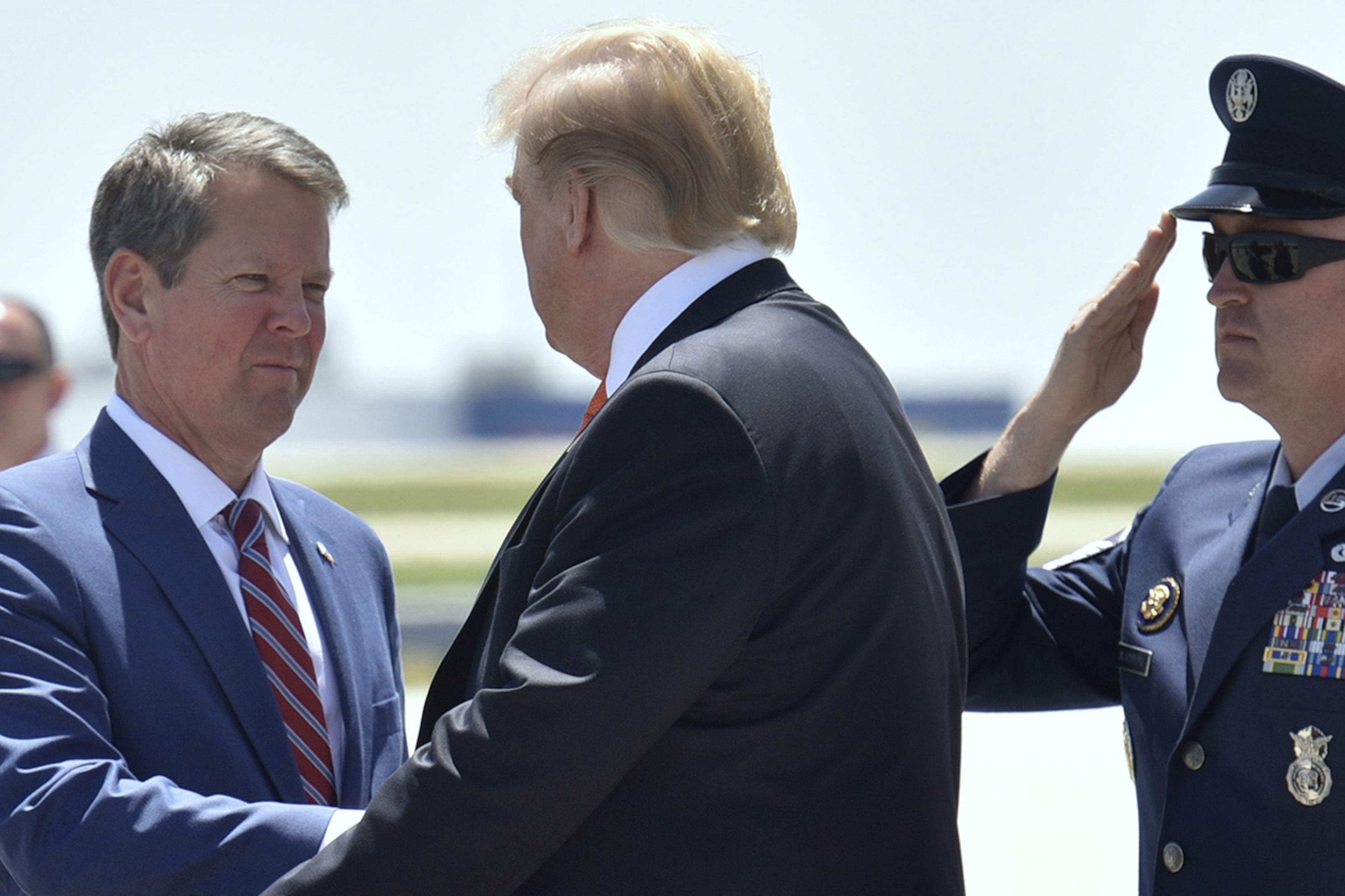 President Donald Trump (right) is greeted by Gov. Brian Kemp in Atlanta in 2019. (Hyosub Shin/AJC)