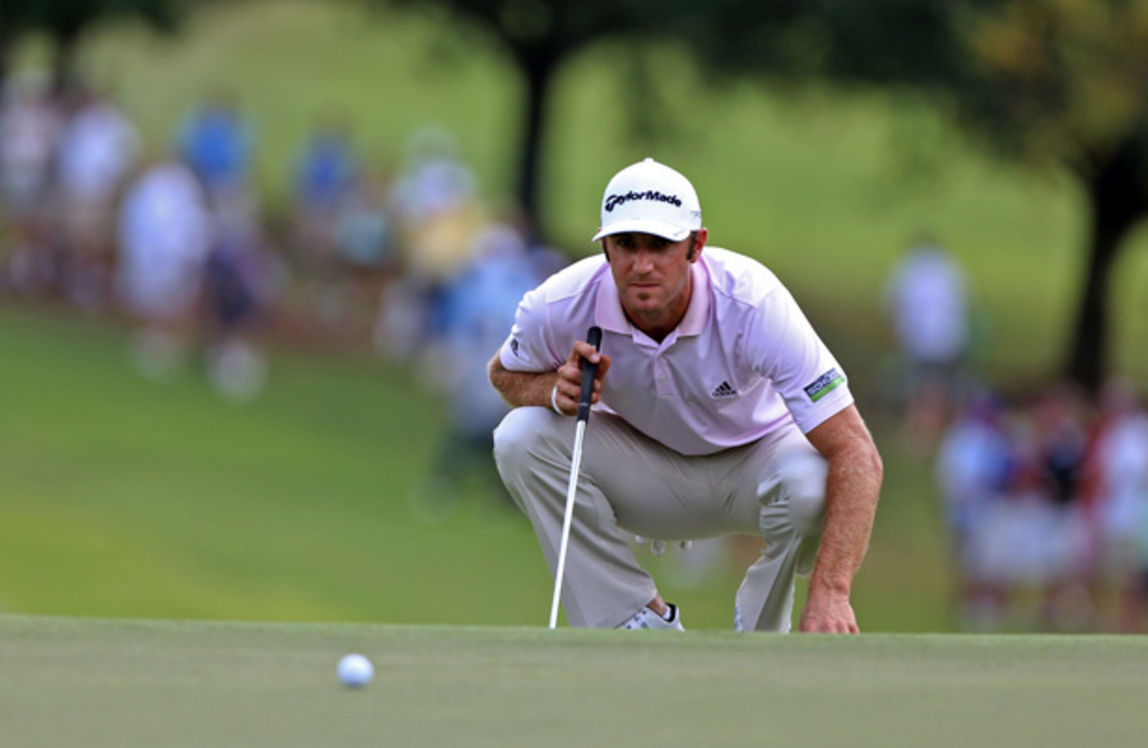 Dustin Johnson lines up his shot on the No. 1 green during Round 2 of the Tour Championship at East Lake Golf Club Friday afternoon in Atlanta.