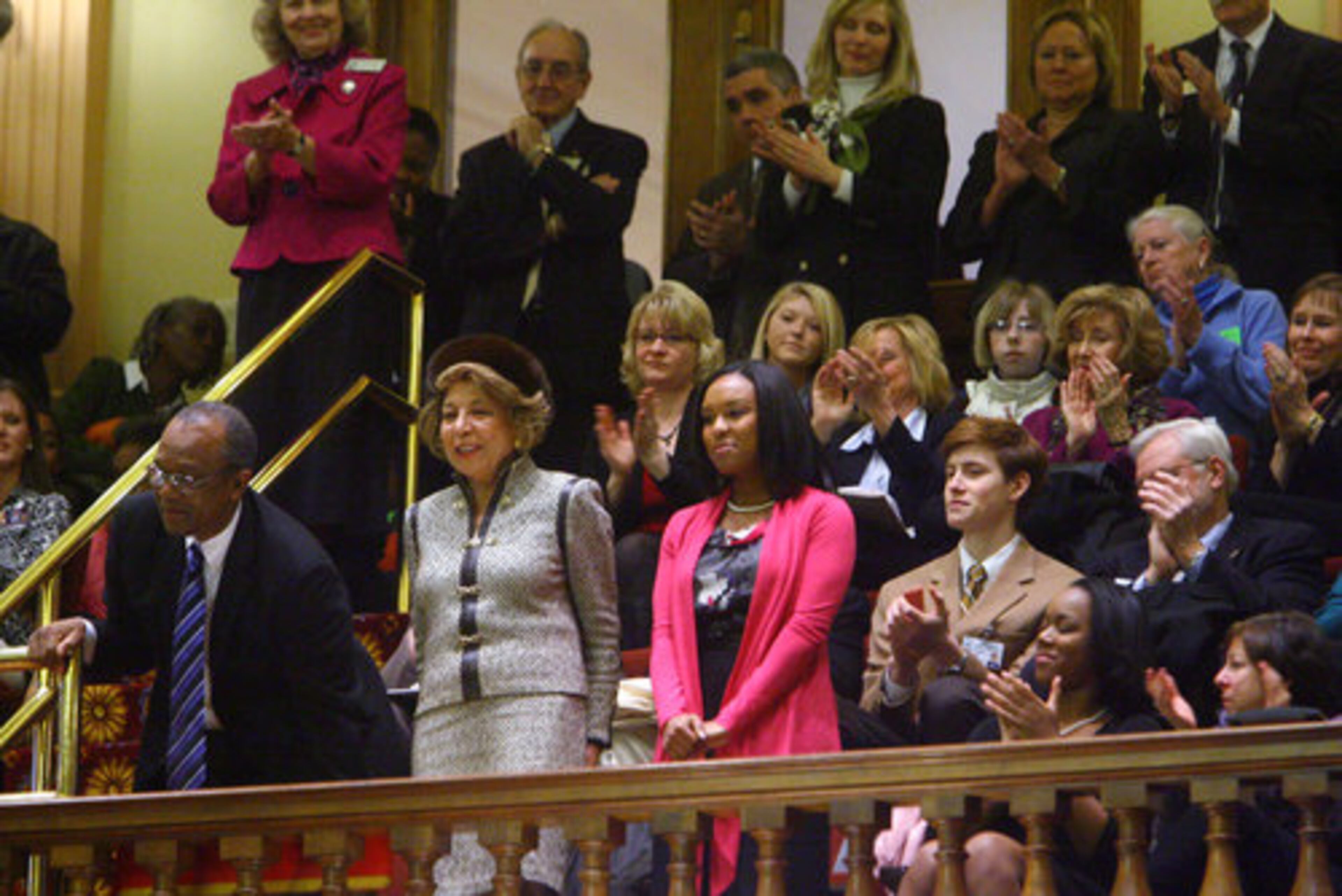 (From left) Chief Justice Leah Ward Sears' husband, Haskell Ward, mother, Onnnye Jean Sears, and daughter, Brennan Sears-Collins, stand during her speech.