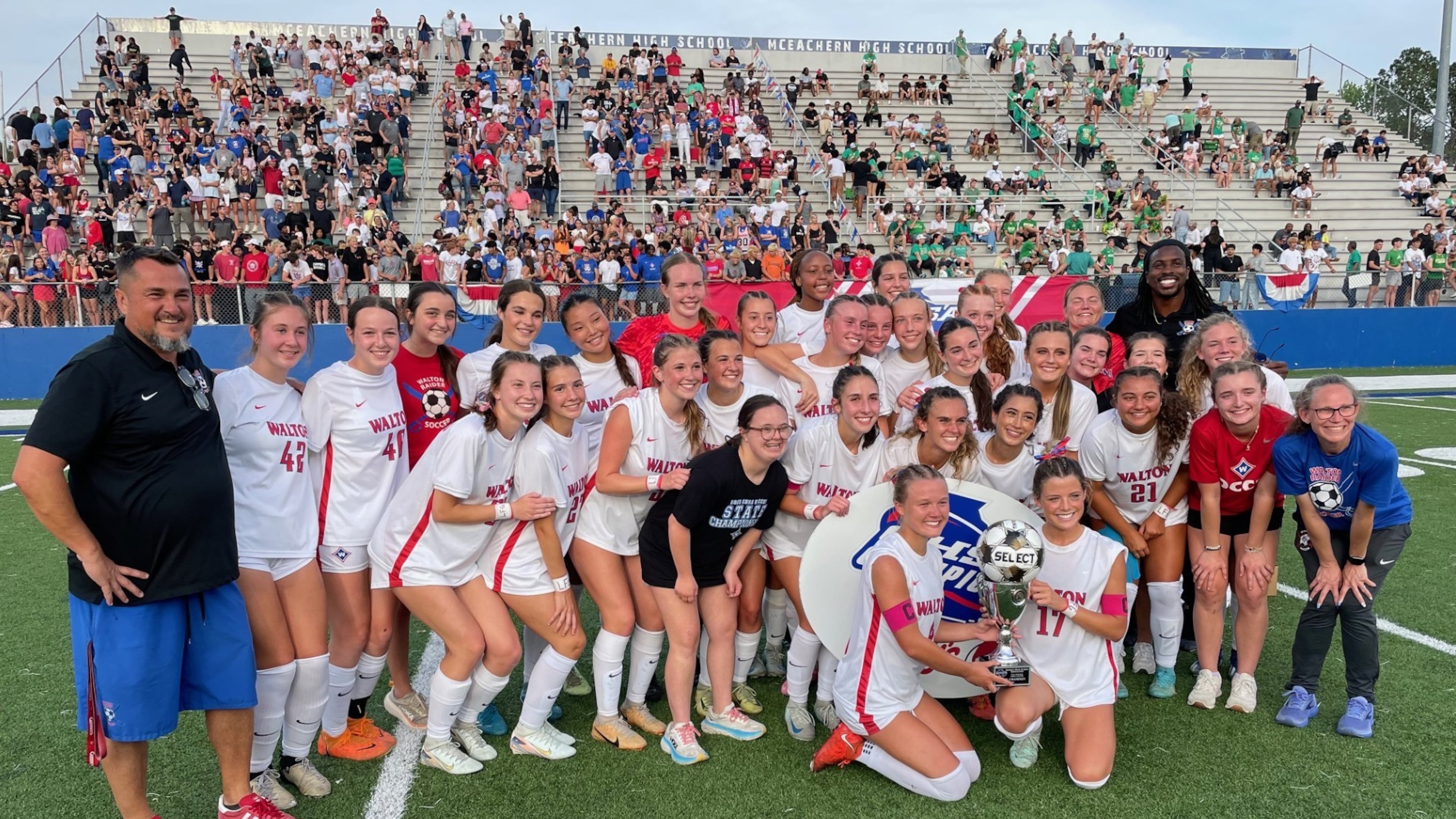 Walton players and coaches celebrate their victory over Buford in the GHSA Class 6A girls soccer championship game at McEachern High School on May 15, 2025.