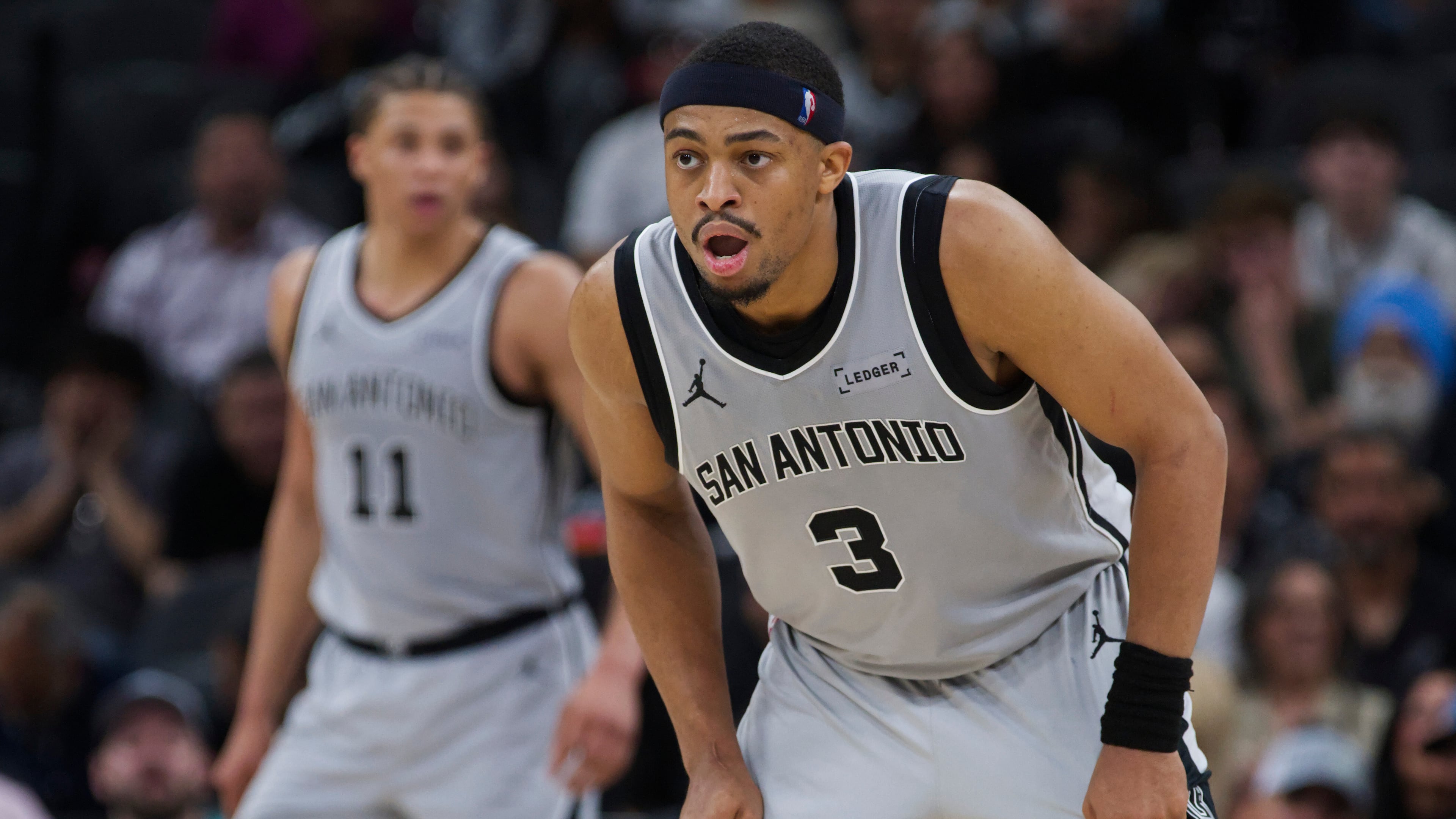 San Antonio Spurs forward Keldon Johnson (3) watches play during the second half of an NBA basketball game against the Portland Trail Blazers, Wednesday, April 8, 2026, in San Antonio. (AP Photo/Darren Abate)