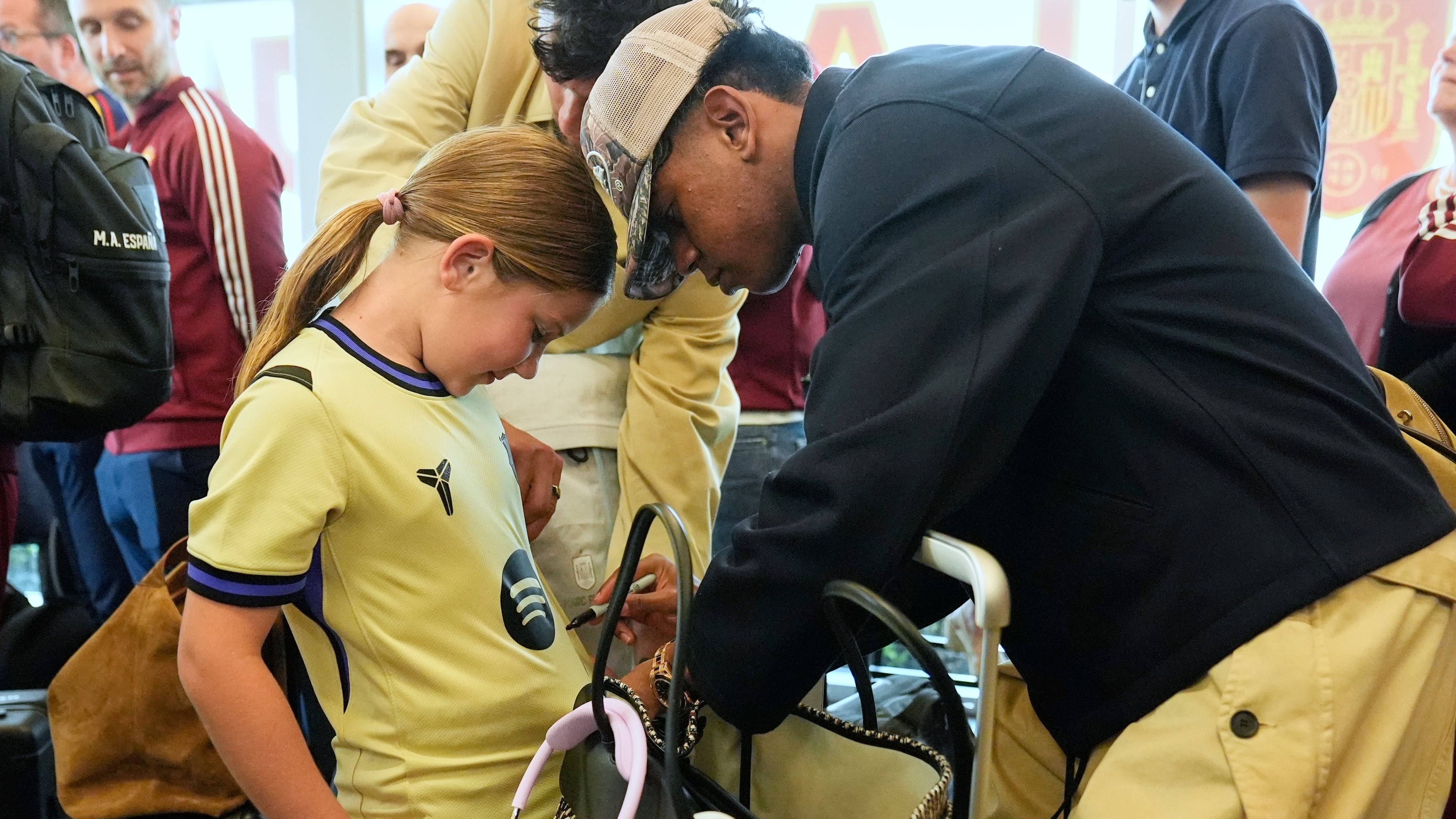 Spain midfielder Lamine Yamal, right, signs an autograph for Griffin Wamp, left, after arriving with teammates for the World Cup soccer tournament Friday, June 5, 2026, in Chattanooga, Tenn. (AP Photo/George Walker IV)