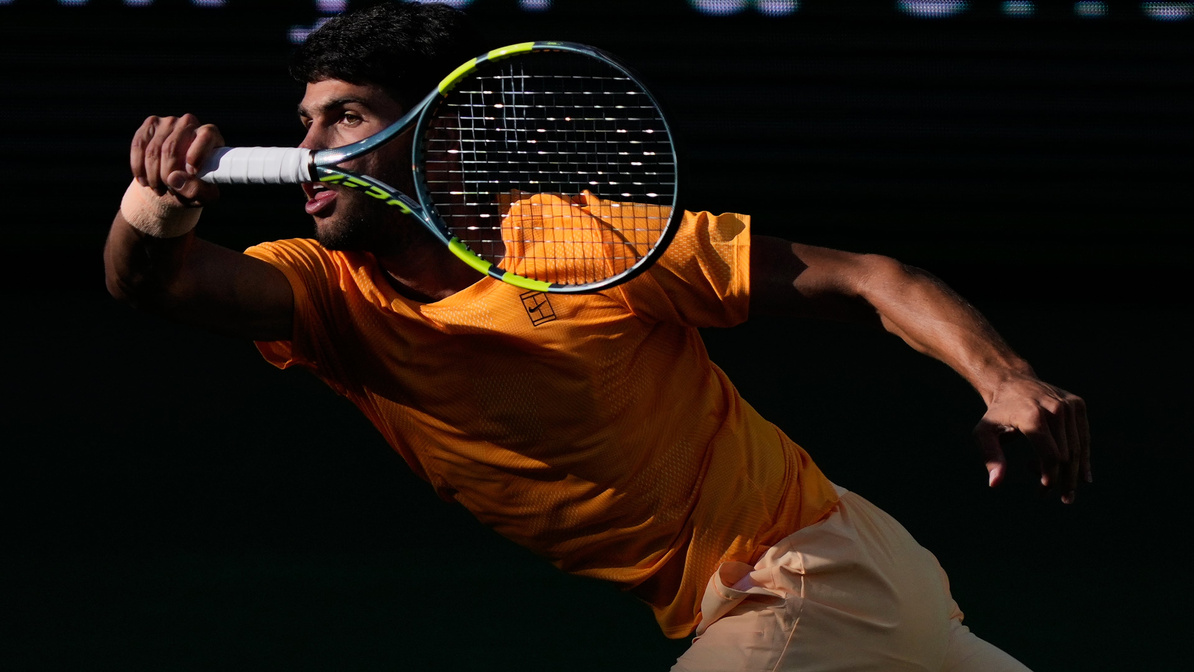 Carlos Alcaraz, of Spain, returns a shot against Daniil Medvedev, of Russia, during a semifinal match at the BNP Paribas Open tennis tournament, Saturday, March 14, 2026, in Indian Wells, Calif. (AP Photo/Mark J. Terrill)