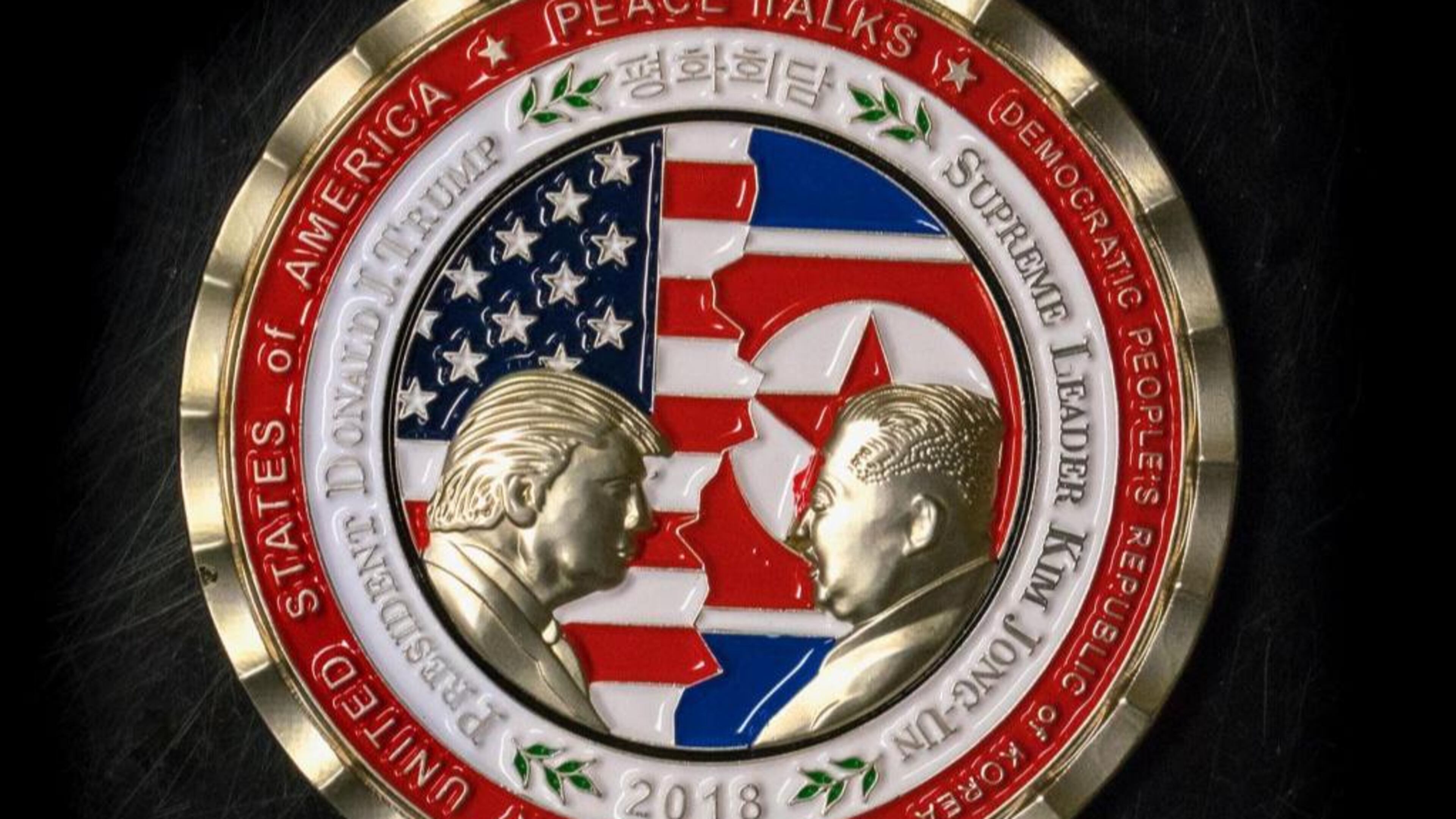 A coin for the US-North Korea summit is seen in Washington, DC, on May 21, 2018. - A commemorative coin featuring US President Donald Trump and North Korea's Kim Jong Un has been struck by the White House Communications Agency ahead of their summit meeting. The coin depicts Trump and Kim, described as North Korea's "Supreme Leader," in profile facing each other in front of a background of US and North Korean flags. The words "Peace Talks" are emblazoned at the top of the front of the coin with the date "2018" beneath. The summit is expected to take place in Singapore on June, 12, 2018. (Photo by STR / AFP) (Photo credit should read STR/AFP/Getty Images)