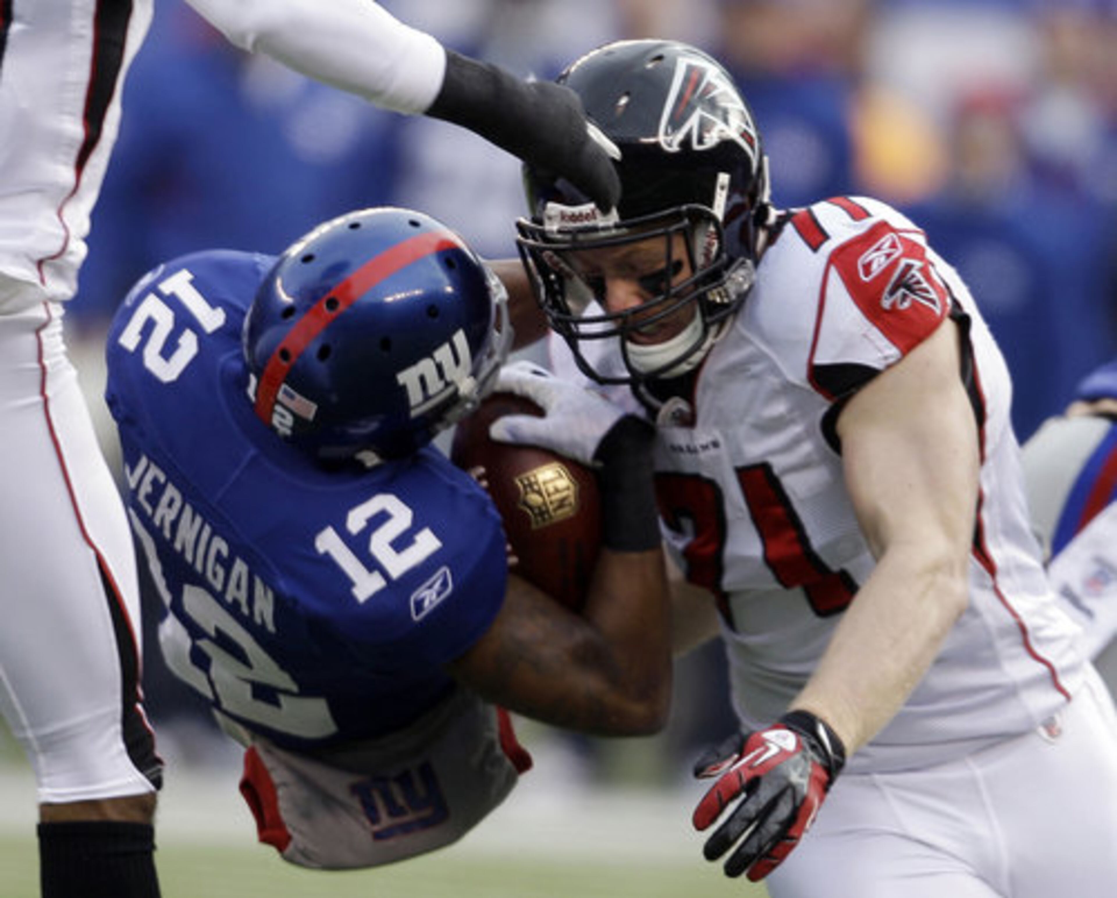 Atlanta Falcons defensive end Kroy Biermann (71) takes down New York Giants wide receiver Jerrel Jernigan (12) after a reception during the first half of an NFL wild card playoff football game Sunday, Jan. 8, 2012, in East Rutherford, N.J.