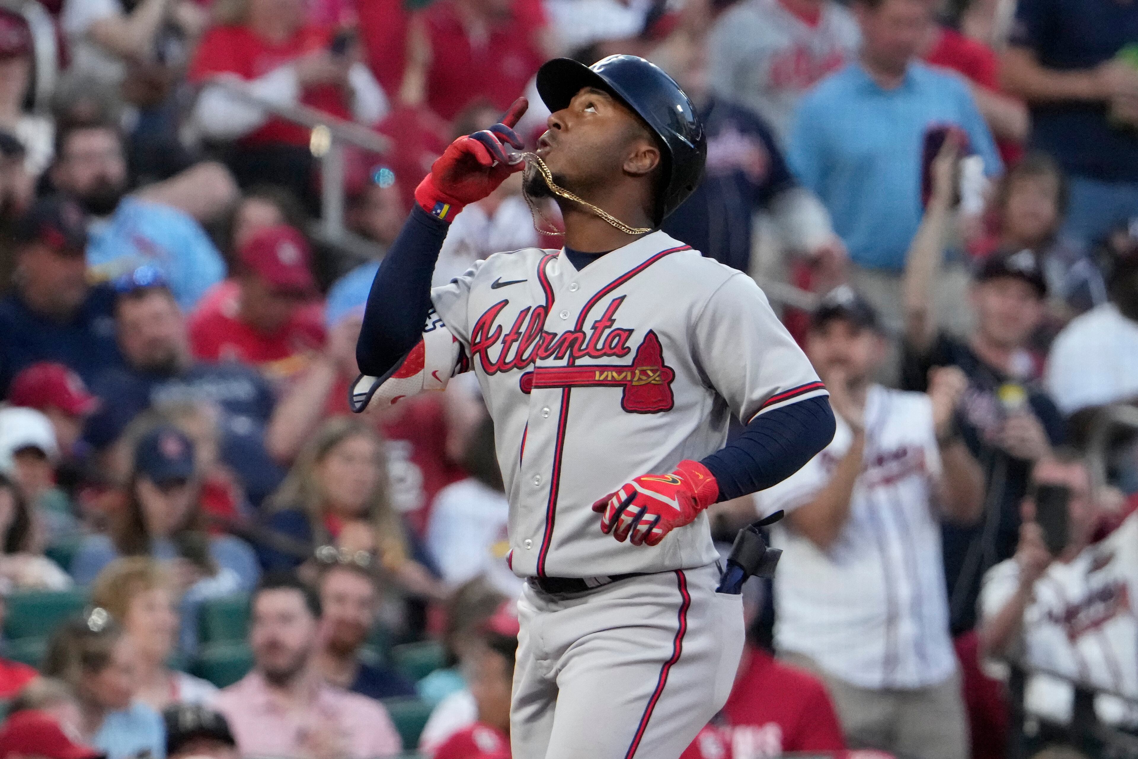 Ozzie Albies celebrates as he arrives home after hitting a two-run home run during the second inning of a baseball game Monday, April 3, 2023, in St. Louis.