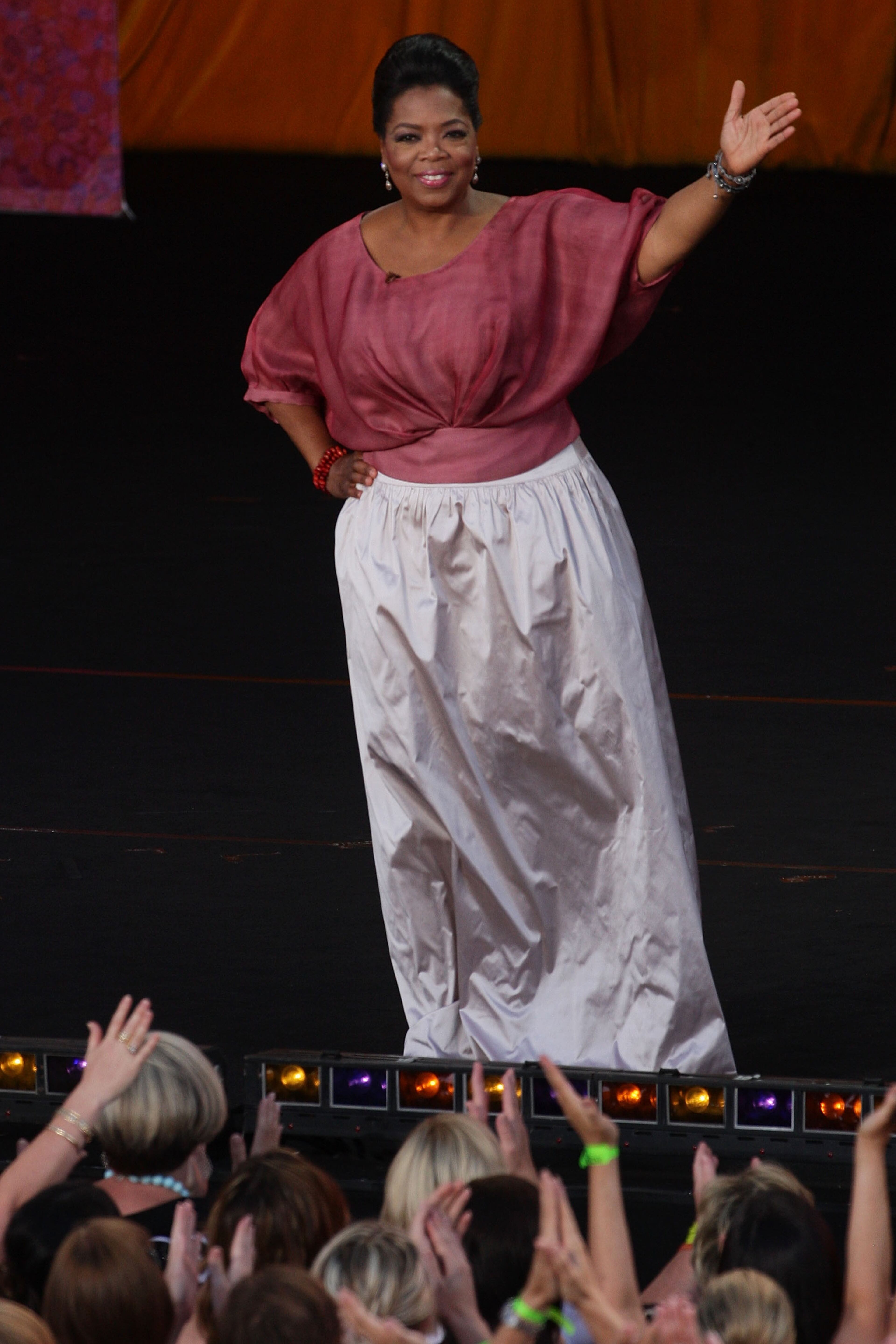 SYDNEY, AUSTRALIA - DECEMBER 14: Oprah Winfrey waves to the audience during the second taping of the 'Oprah Winfrey Show' at the Sydney Opera House on December 14, 2010 in Sydney, Australia. 12,000 audience members were selected from 350,000 applicants to participate in two tapings of 'The Oprah Winfrey Show' at the Sydney Opera House. Oprah descended on Australia last week with 302 super fans from the US, Canada and Jamaica to produce four shows for the 25th and final season of the program. the shows will air in the US and Australia in January 2011. (Photo by Lisa Maree Williams/Getty Images)