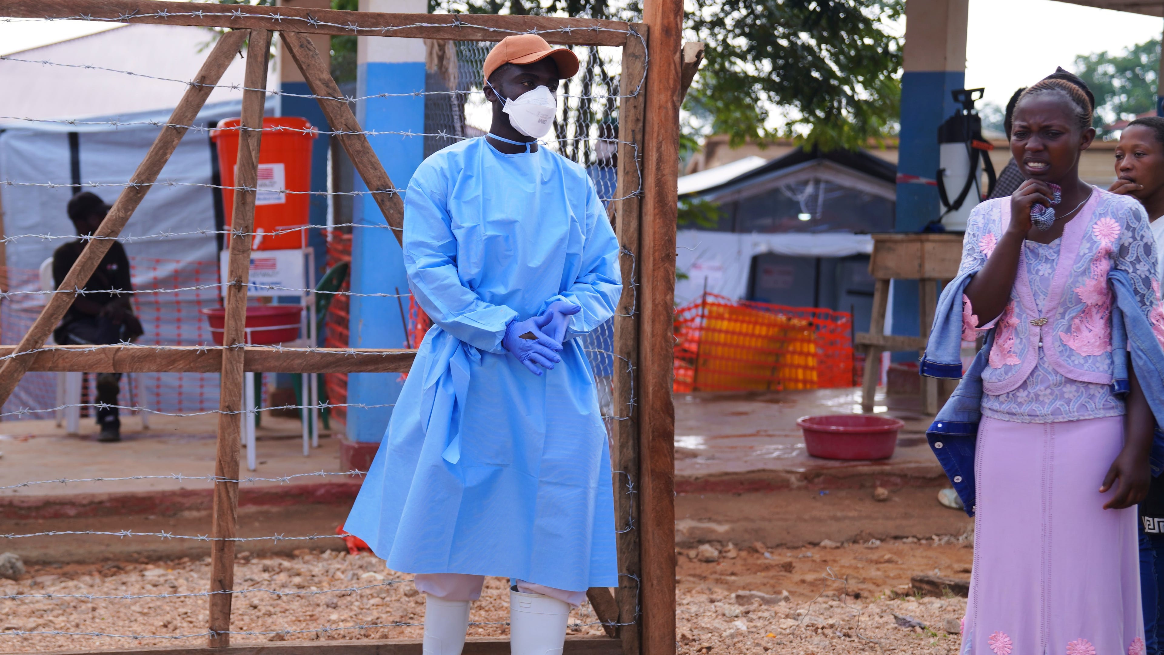 Residence watch as health workers carry a coffin of an Ebola victim at Ebola Treatment Center at Bunia General Hospital in Ituri, Congo, Wednesday, July 22, 2026. (AP Photo/Dirole Lotsima Dieudonne)