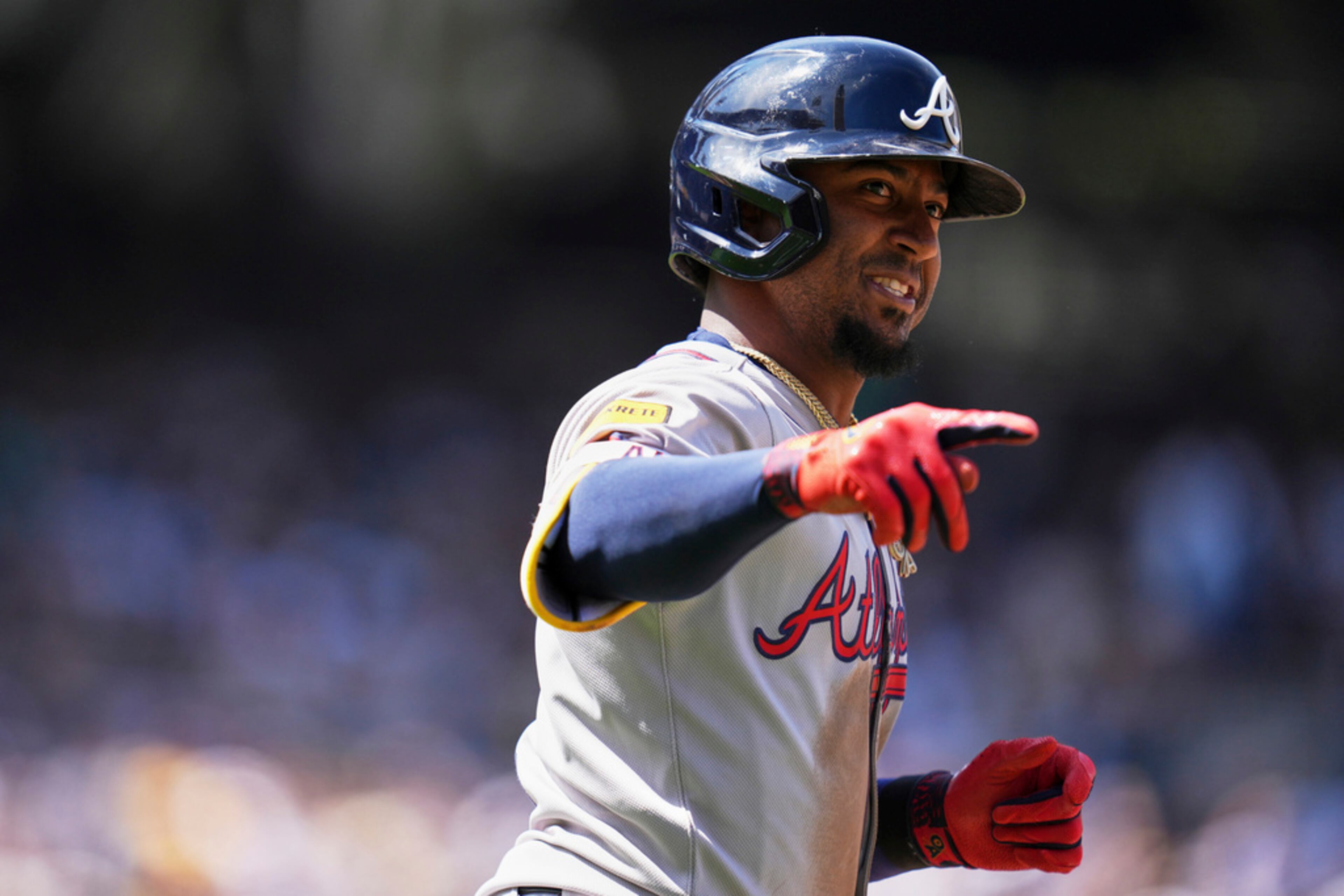 Atlanta Braves' Ozzie Albies reacts after hitting a two-run home run during the third inning of an opening-day baseball game against the San Diego Padres Thursday, March 27, 2025, in San Diego. (AP Photo/Gregory Bull)