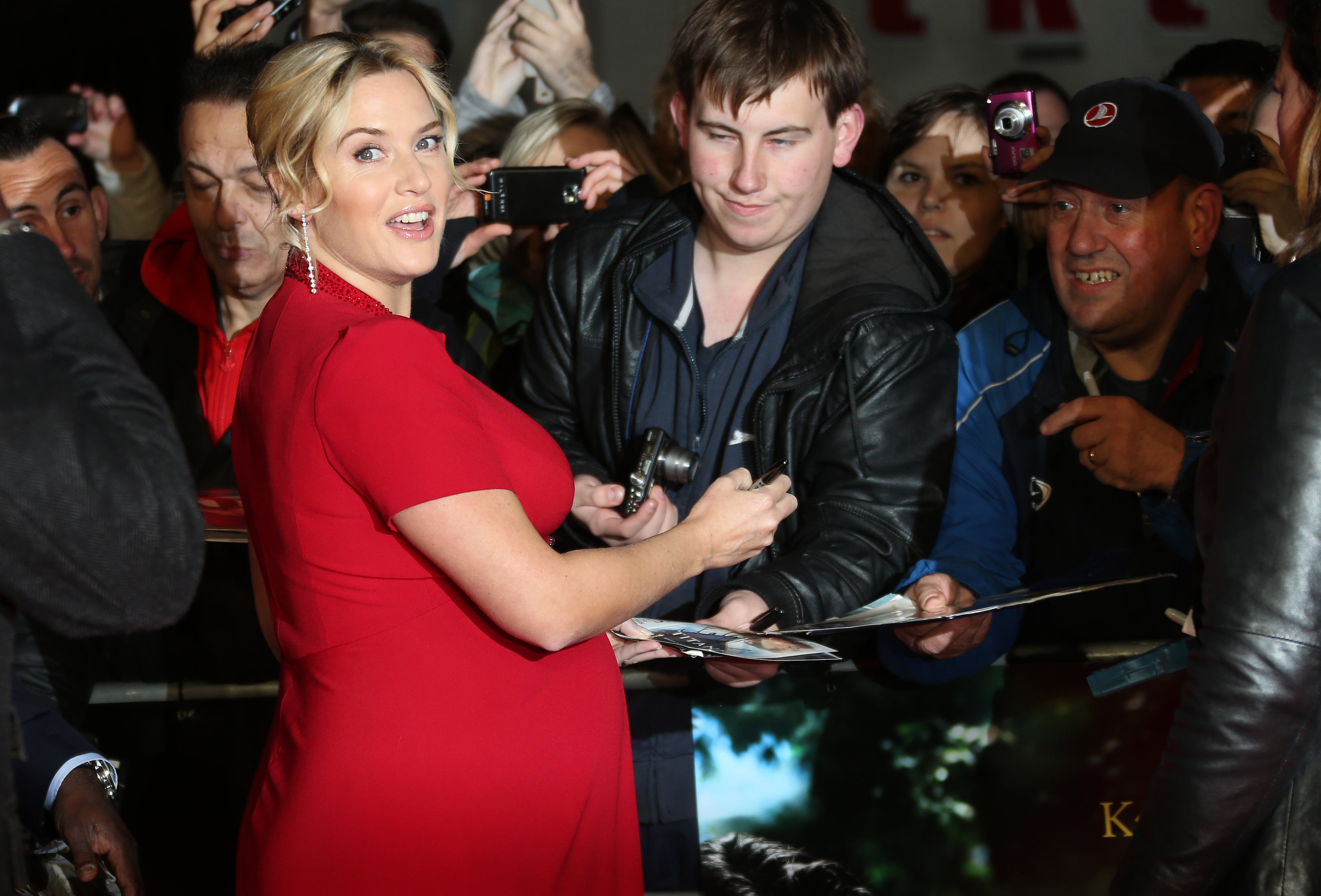 British Actress Kate Winslet signs autographs for fans as she arrives on the red carpet for the gala screening of the film Labor Day, as part of the 57th BFI London Film Festival, at a central London cinema, Monday, Oct. 14, 2013.