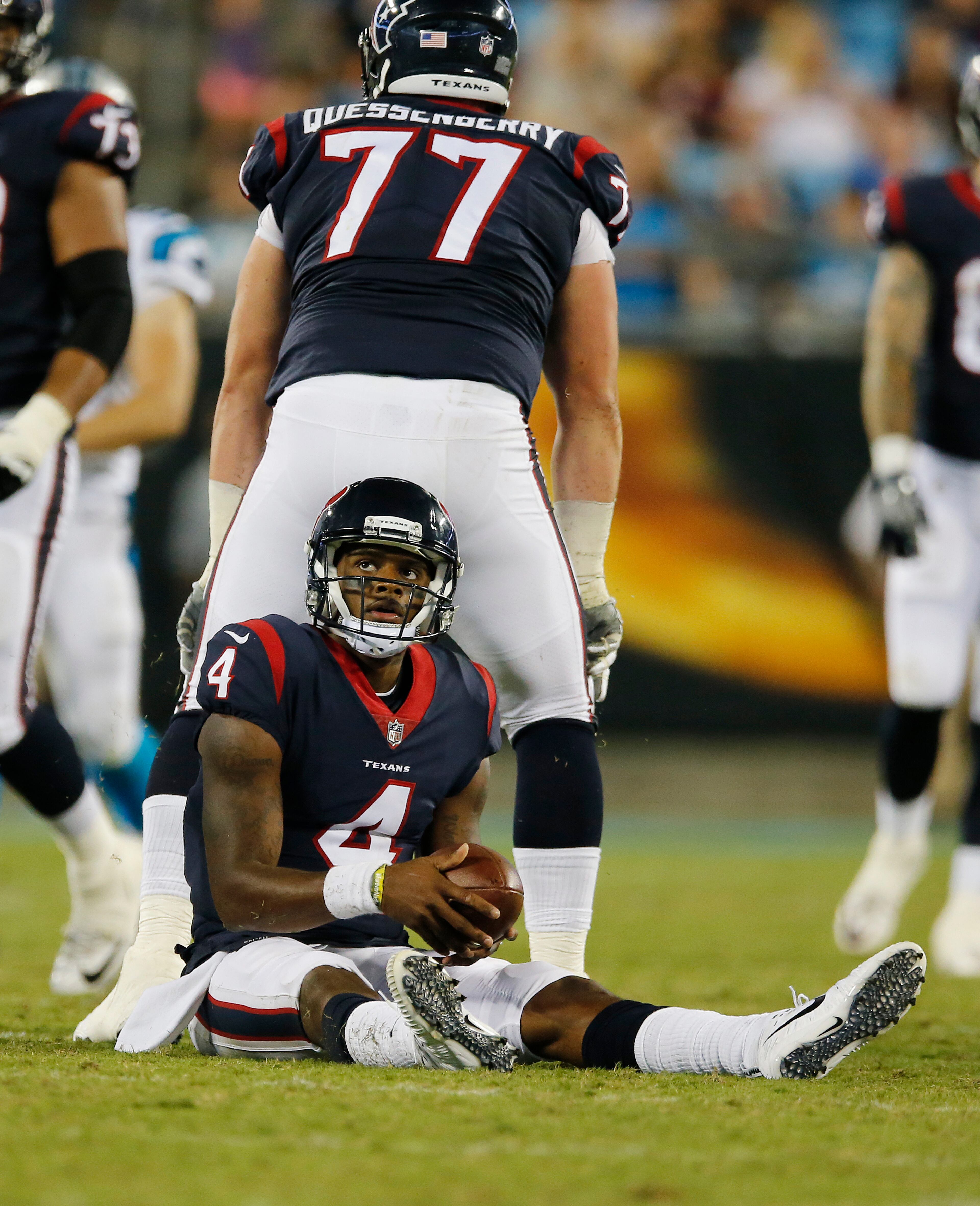 Houston Texans quarterback Deshaun Watson (4) watches the replay after being sacked by the Carolina Panthers during the second half of an NFL preseason football game, Wednesday, Aug. 9, 2017, in Charlotte, N.C. (AP Photo/Jason E. Miczek)