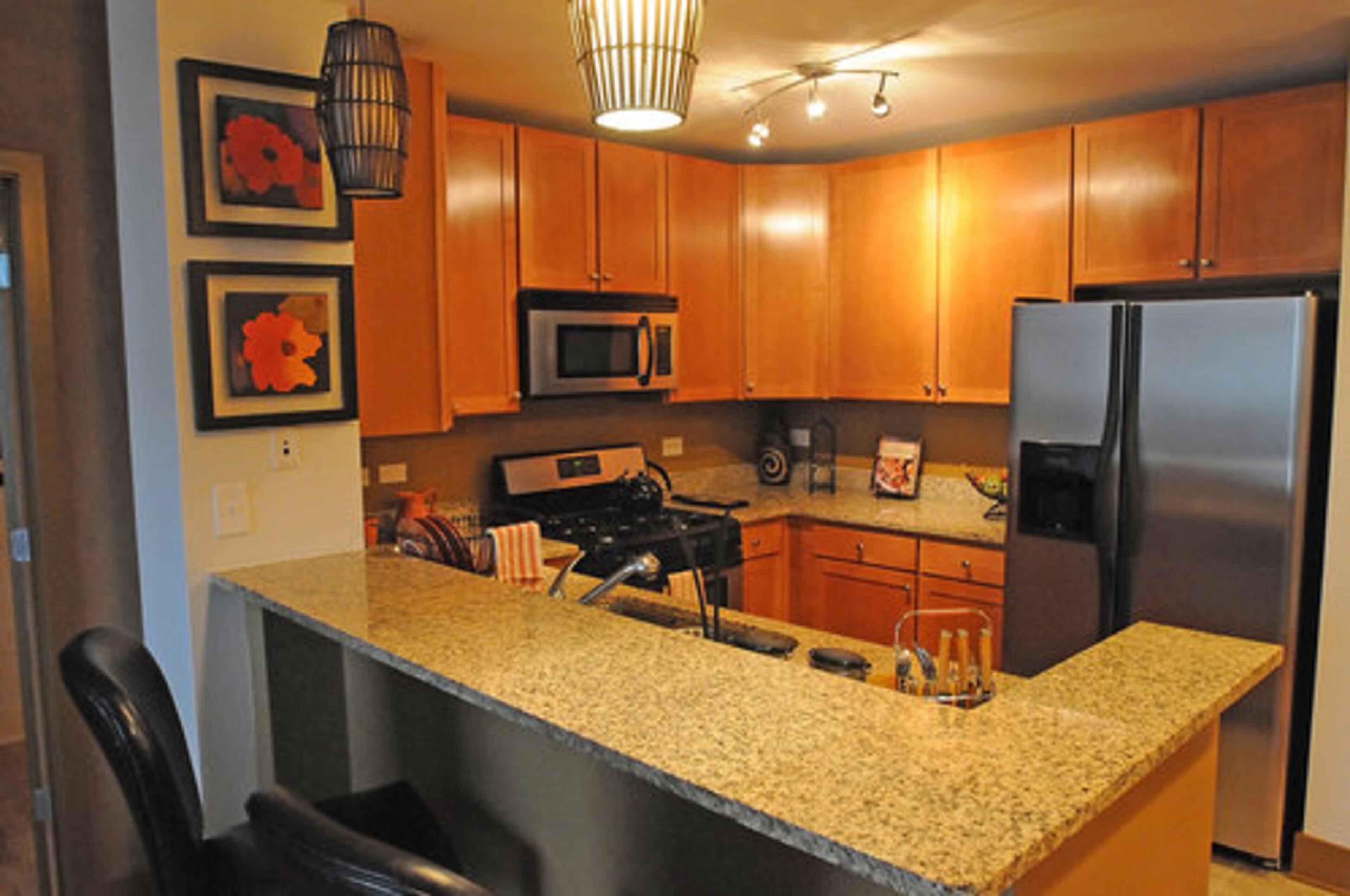 The kitchen of a model unit. Granite countertops and double sinks in the kitchen are just two of the high-end features that Rhoden loves about her home.