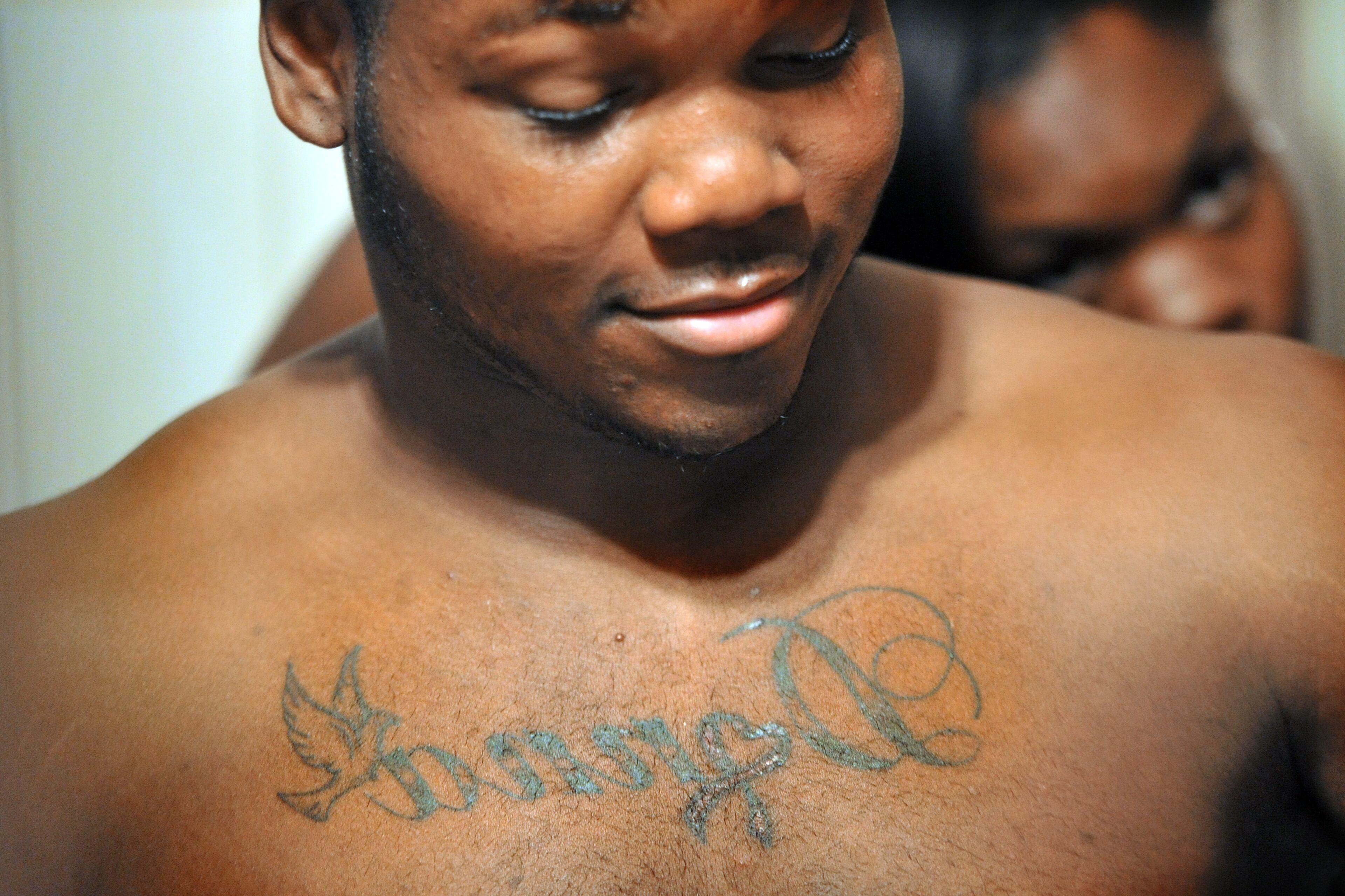 Darius Marshall, 18, has his mother's named tattooed across his chest. He's very proud of it but says it hurt when he had it done. HYOSUB SHIN / HSHIN@AJC.COM