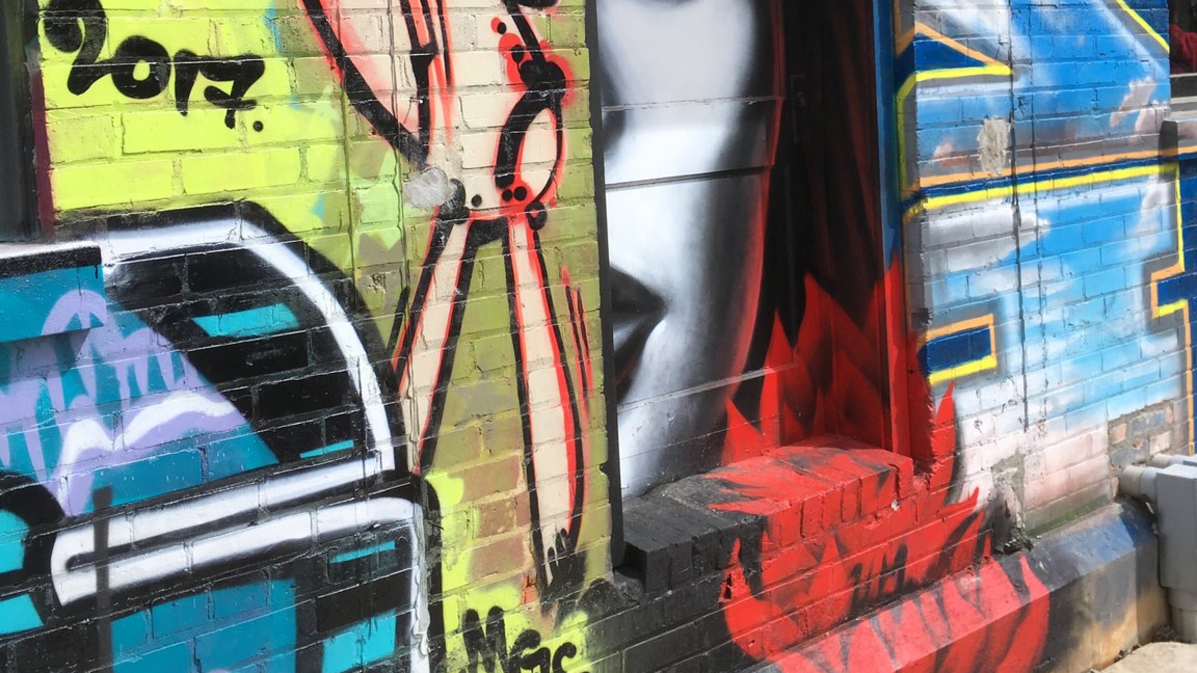 Graffiti decorates the walls of the Wedge Brewing and 12 Bones Smokehouse complex in Asheville’s River Arts District. PHOTO CREDIT: Bob Townsend.