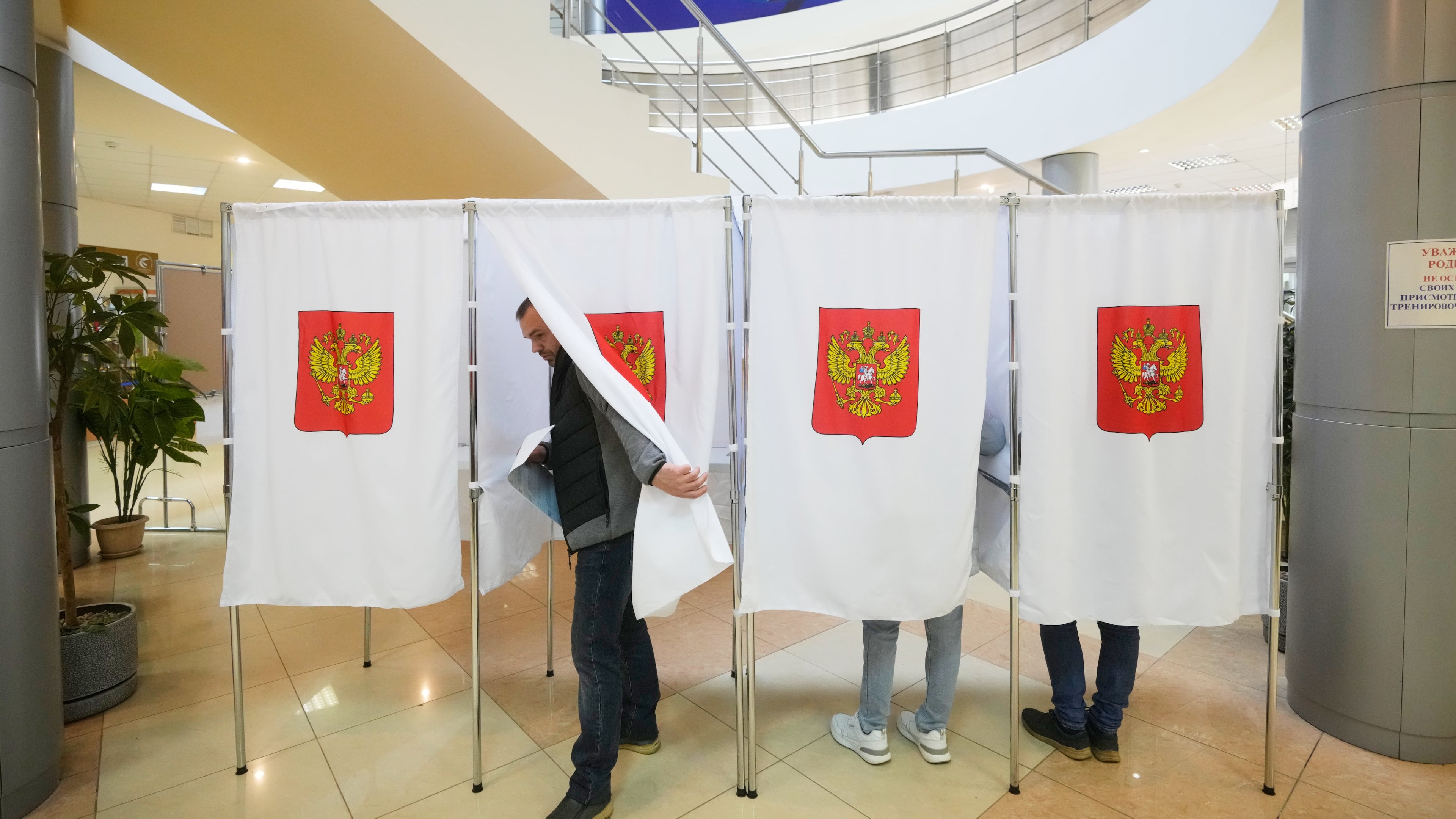 A voter leaves a polling booth after casting a vote during the parliamentary election in Podolsk, Moscow region, Russia, Saturday, Sept. 19, 2026. (AP Photo/Pavel Bednyakov)