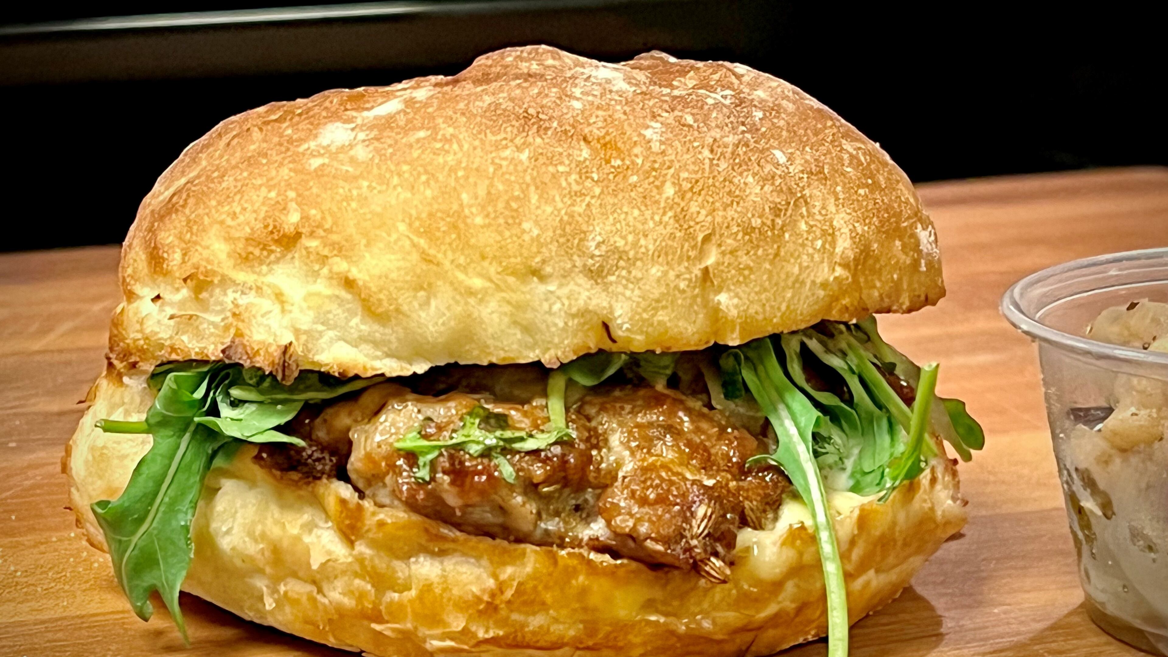 The salsiccia panino from Bellina Alimentari has a house-made Italian sausage inside a ciabatta roll. Henri Hollis/henri.hollis@ajc.com