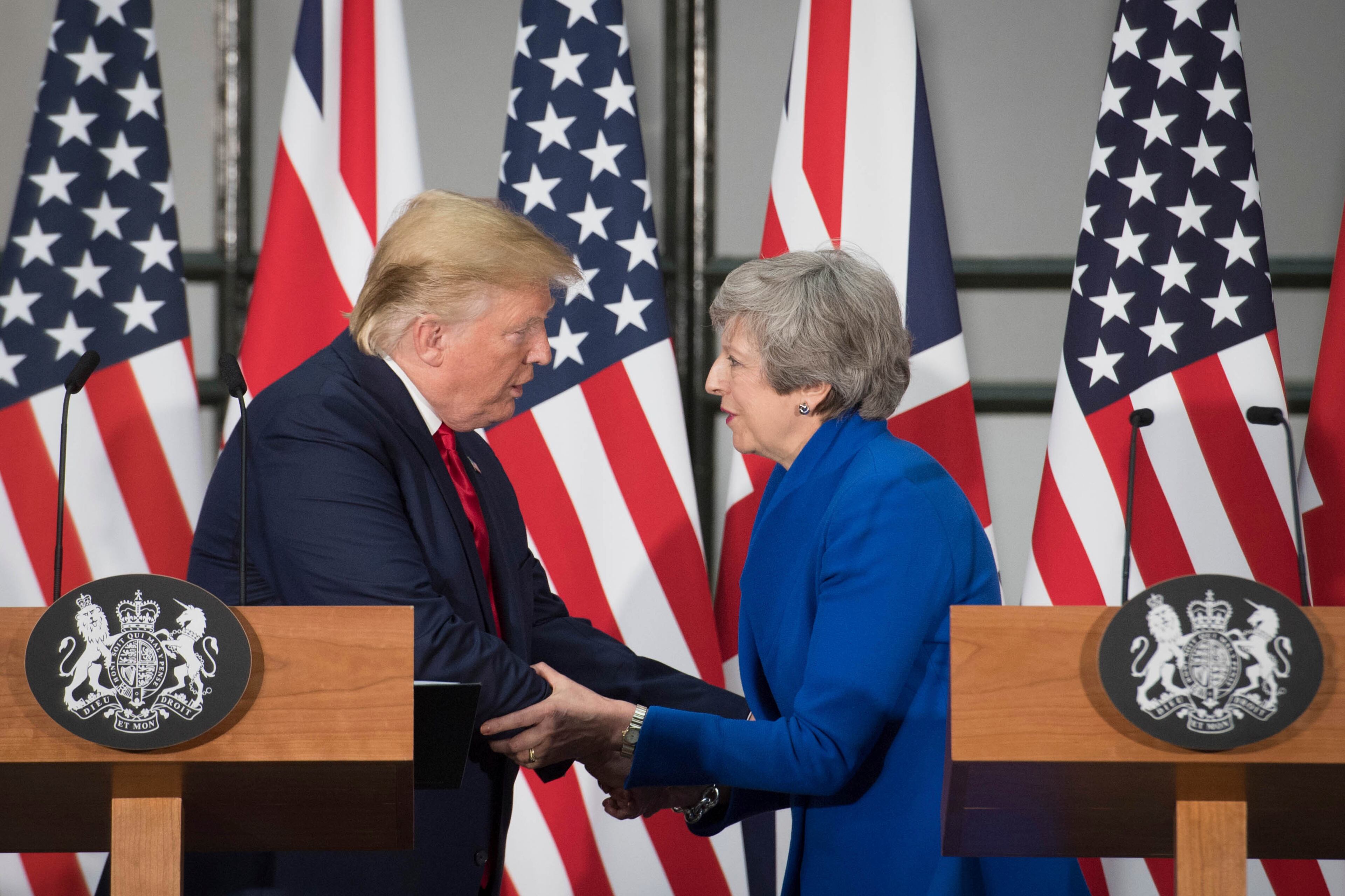 Britain's Prime Minister Theresa May and US President Donald Trump take part in a joint press conference at the Foreign & Commonwealth Office, in London, Tuesday June 4, 2019. Moving from pageantry to policy during his state visit to Britain, President Donald Trump on Tuesday urged embattled Prime Minister Theresa May to "stick around" to complete a U.S.-U.K. trade deal, adding to this recent chapter of uncertainty in the allies' storied relationship. (Stefan Rousseau/Pool via AP)
