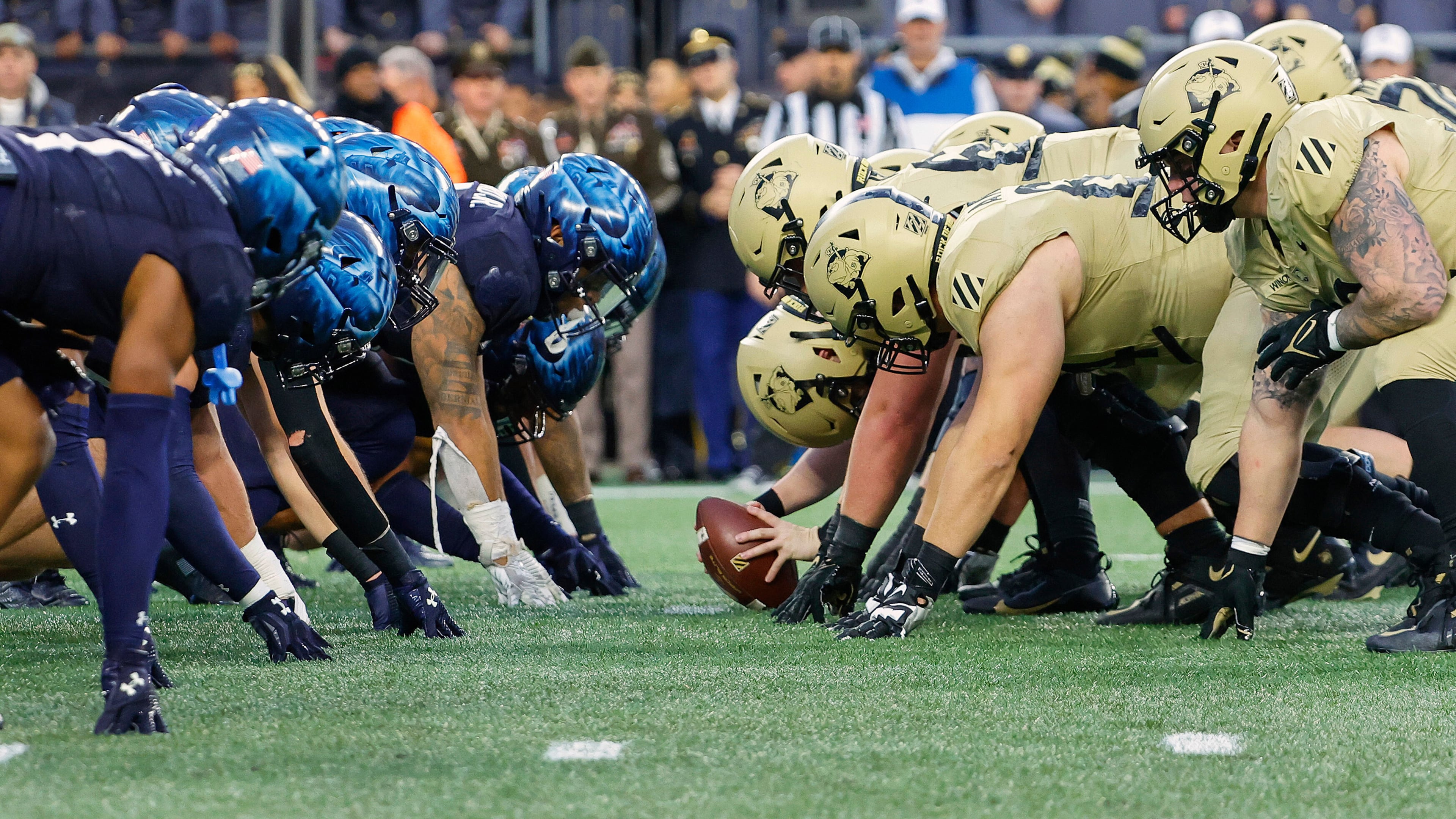 FILE - The Navy, left, and Army line up for the snap at the line of scrimmage during the first quarter of an NCAA football game at Gillette Stadium Saturday, Dec. 9, 2023, in Foxborough, Mass. (AP Photo/Winslow Townson, File)