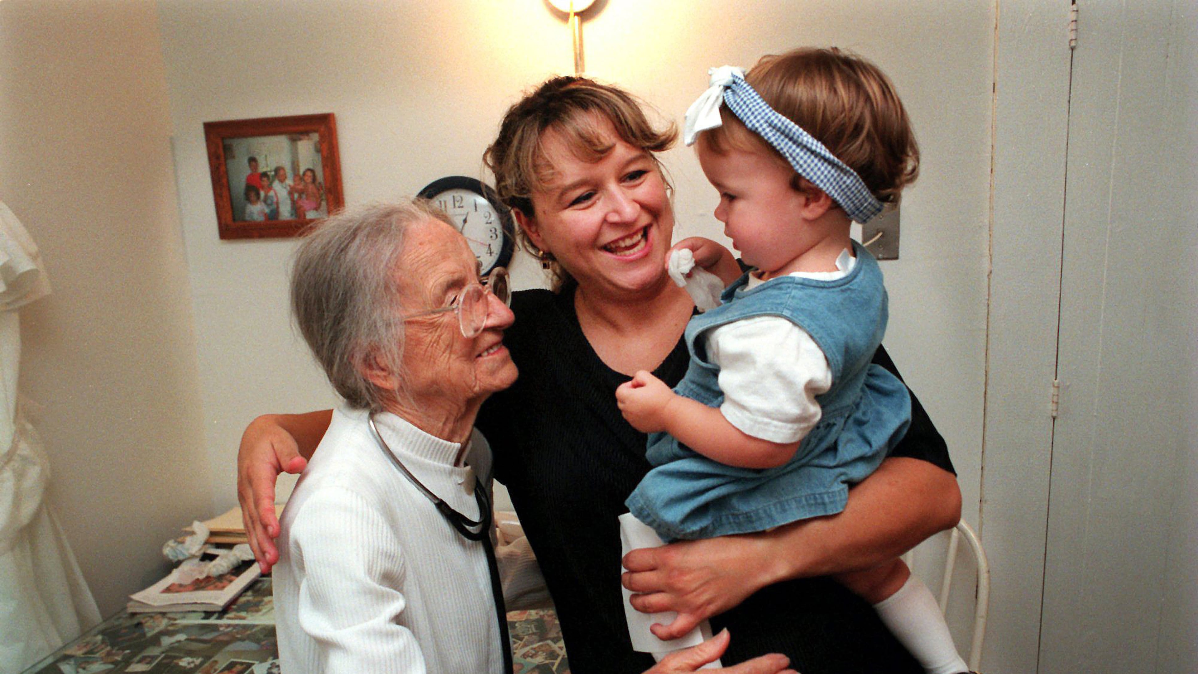 EMBRACING HER DOCTER--Scarlett Jimison (cq), center, and her 14-month-old daughther, Amber (cq), hug 100-year-old Dr. Leila Denmark (cq), goodbye after an office visit at her125-year-old farmhouse on Monday, September 14, 1998. Jimison, who is from Buckhead, Ga., has been coming to Denmark since she was an infant and now brings her daughter. Amber was suffering from a cold. (CURTIS COMPTON/staff)