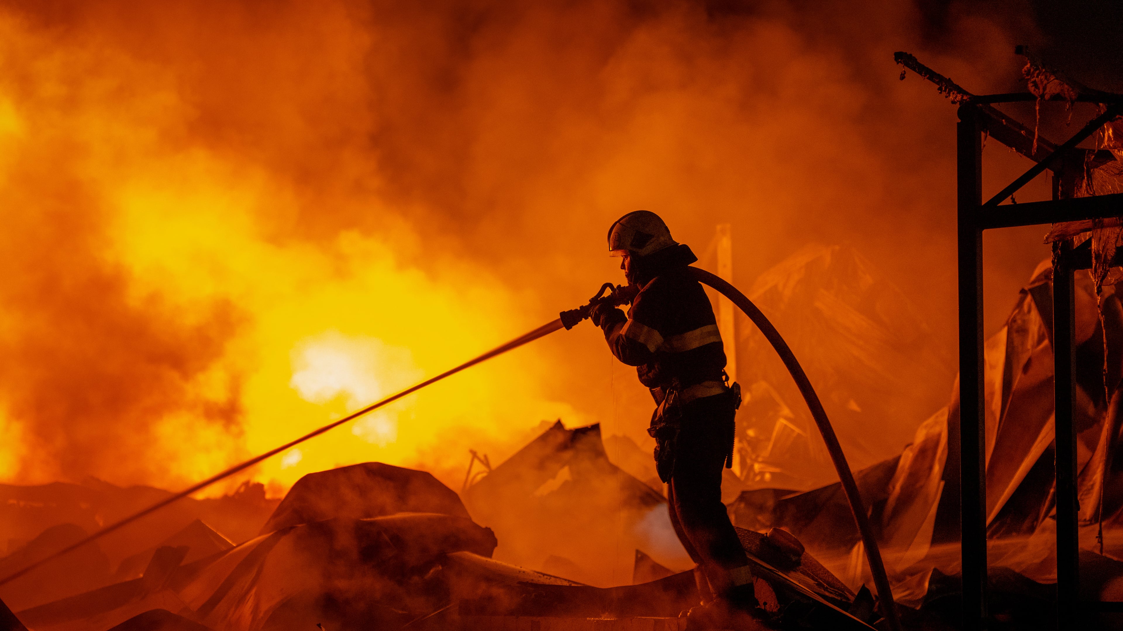 Firefighters put out a fire after Russian missiles hit a warehouse in Kyiv, Ukraine, Wednesday, Aug. 5, 2026. (AP Photo/Dan Bashakov)
