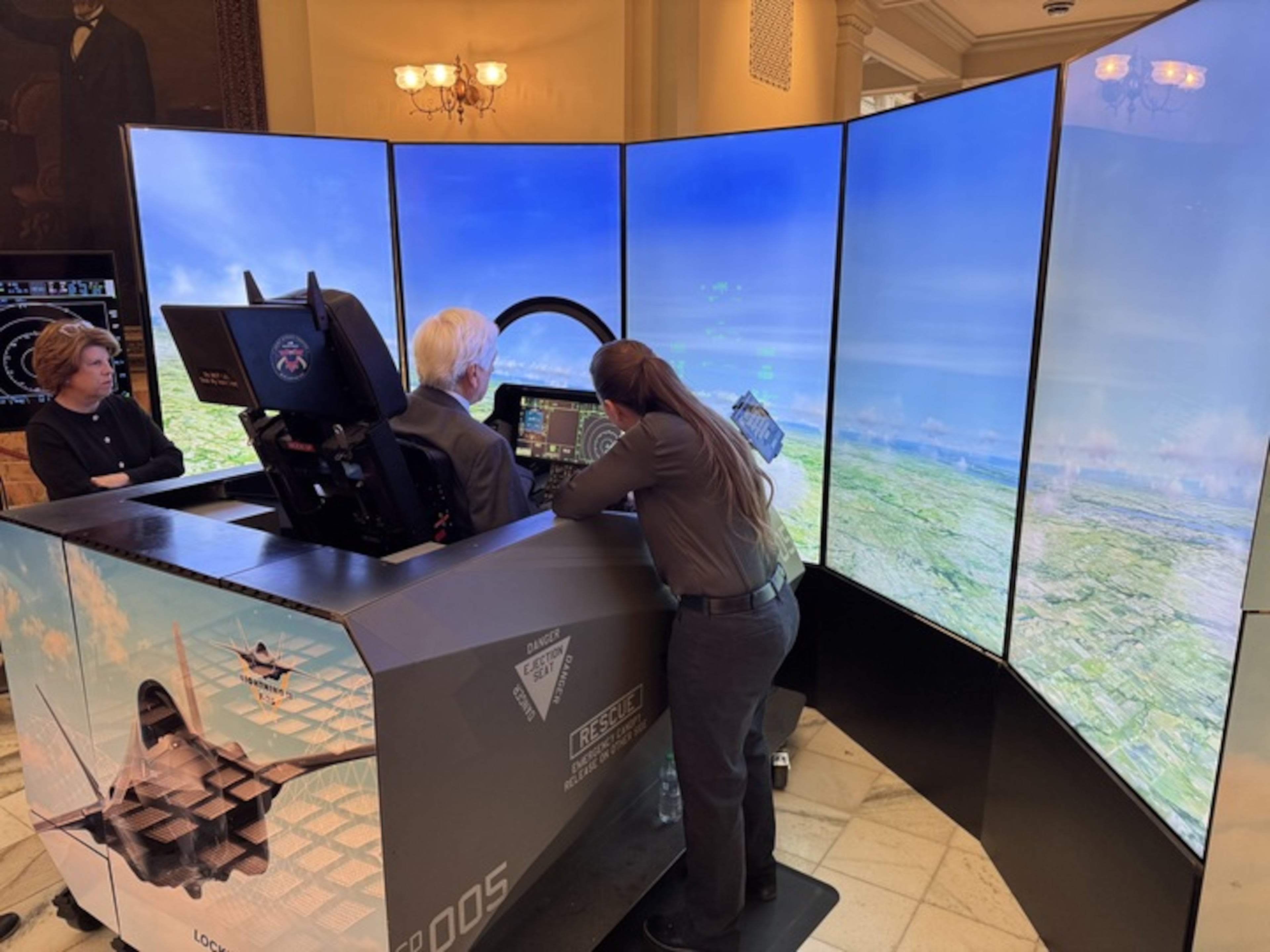 People took turns operating a F-35 simulator at the Capitol in Atlanta on Tuesday. (Adam Beam/AJC)