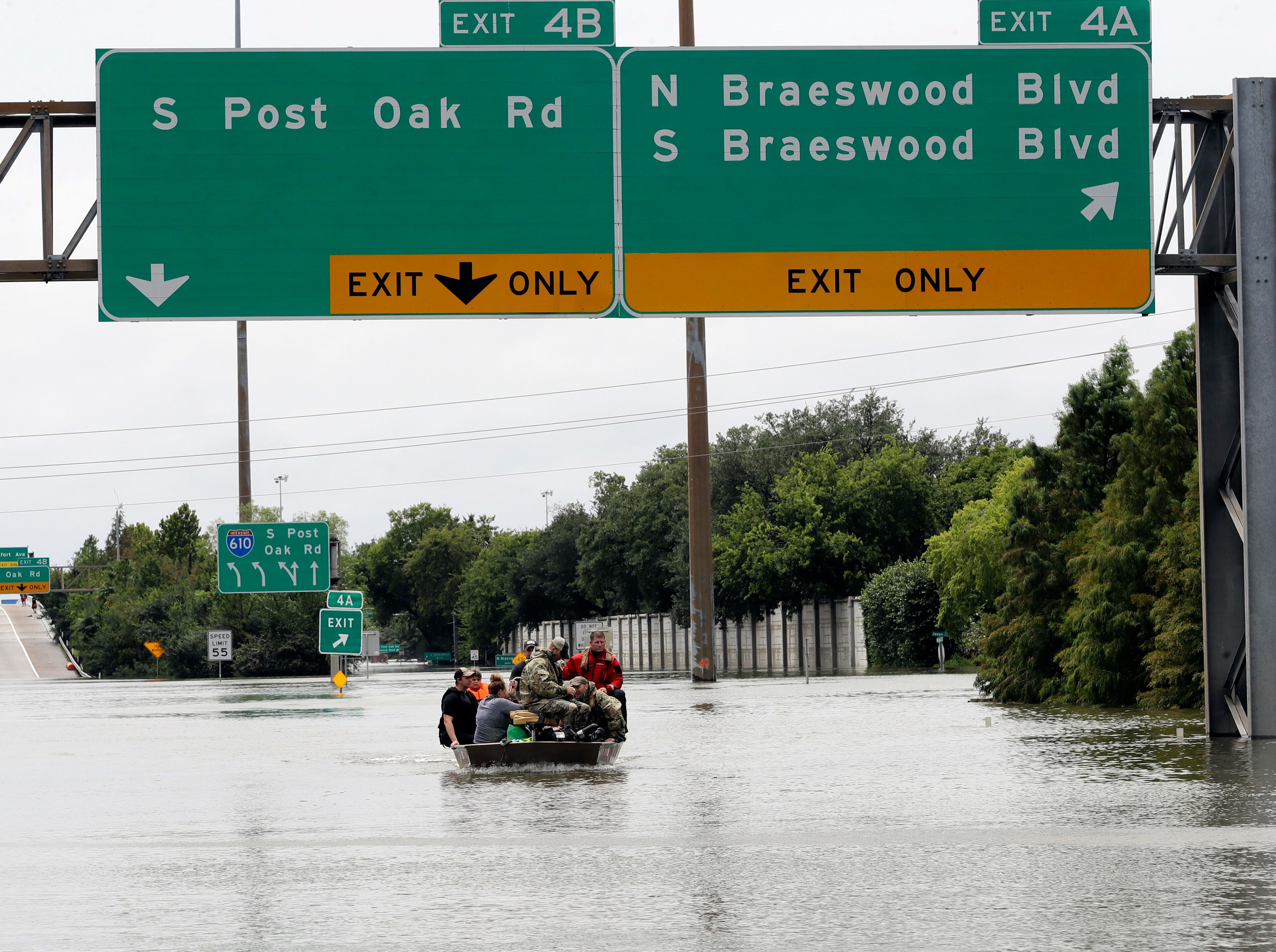 Residents are rescued from their homes surrounded by floodwaters from Tropical Storm Harvey on Sunday, Aug. 27, 2017, in Houston, Texas. (AP Photo/David J. Phillip)