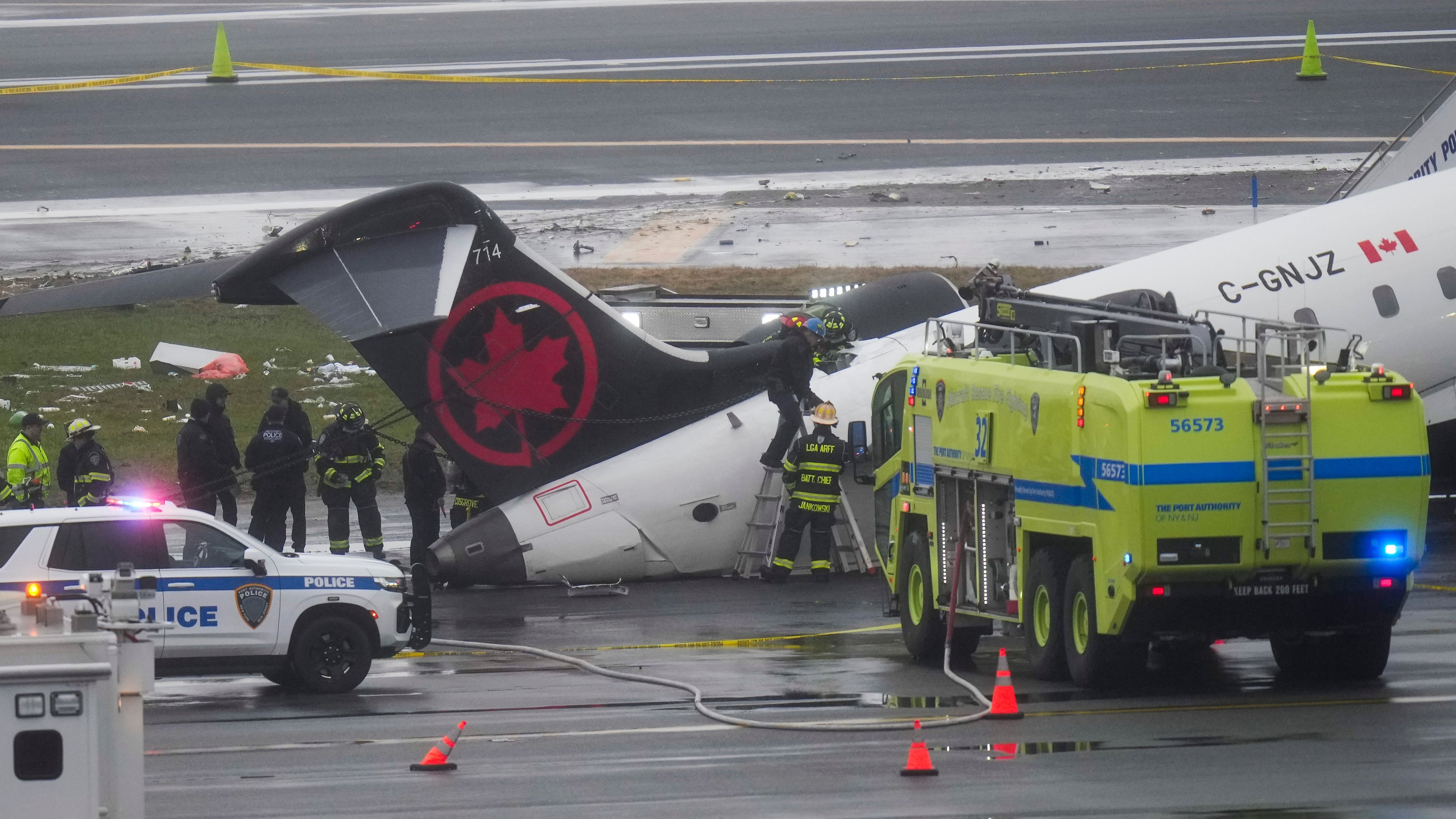 FILE - Firefighters and investigators examine the site, March 23, 2026, where an Air Canada jet came to rest after colliding with a Port Authority firetruck at LaGuardia Airport, after landing Sunday night in New York. (AP Photo/Seth Wenig, File)
