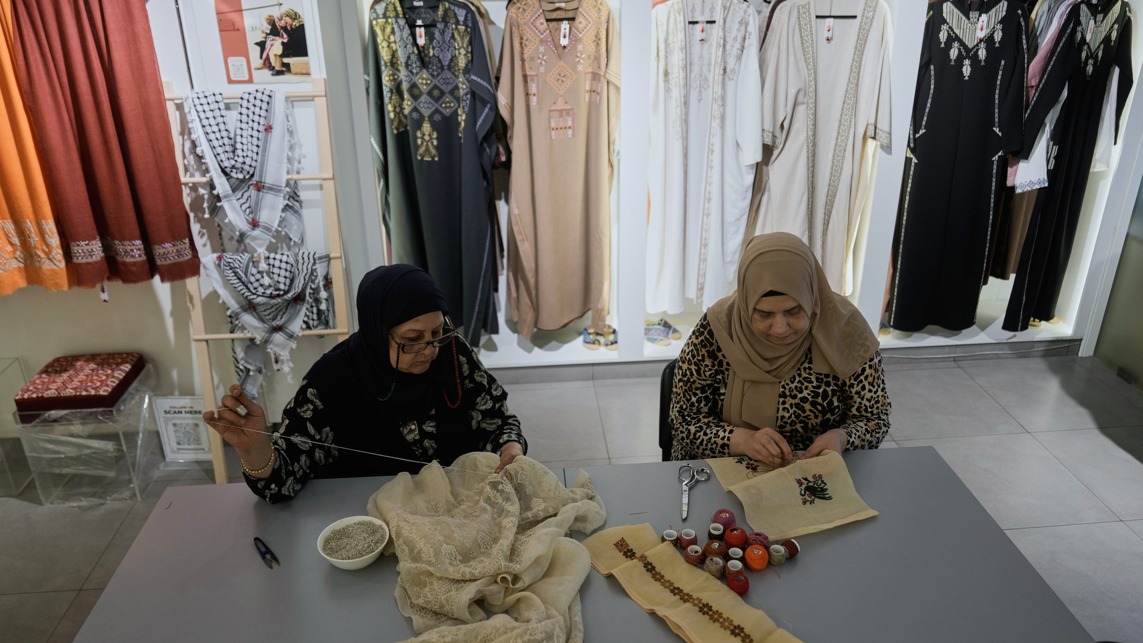 Palestinian weavers Rula Barakeh, right, and Samira Nasser work on handmade embroidered pieces at the Inaash Association embroidery workshop in Beirut, Tuesday, May 19, 2026. (AP Photo/Bilal Hussein)