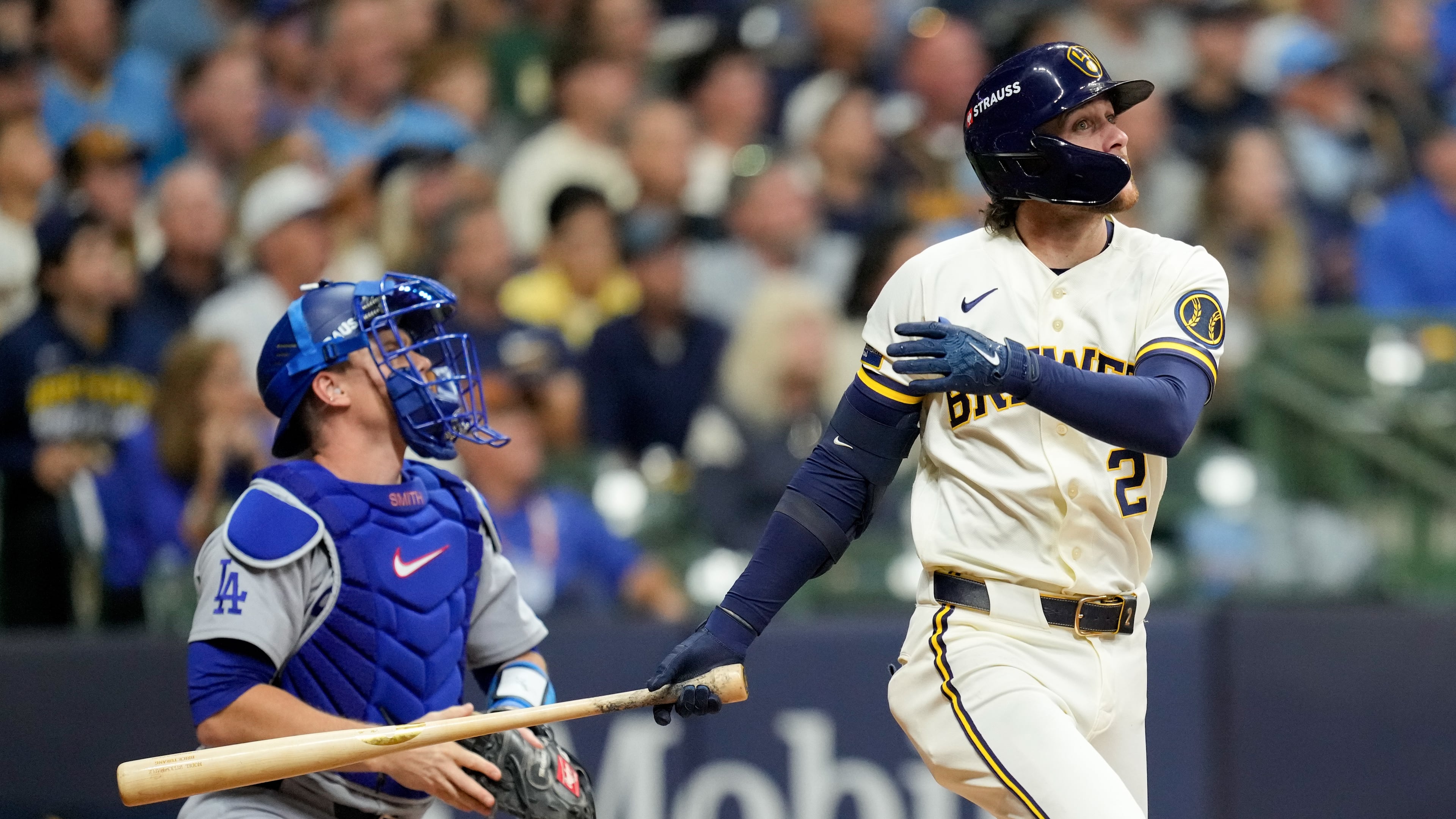 Milwaukee Brewers second baseman Brice Turang and Los Angeles Dodgers catcher Will Smith watch his solo home run take flight during the fourth inning of Game 1 of baseball's National League Championship Series between the Milwaukee Brewers and the Los Angeles Dodgers, Sunday, Oct. 11, 2026, in Milwaukee. (AP Photo/Ashley Landis)