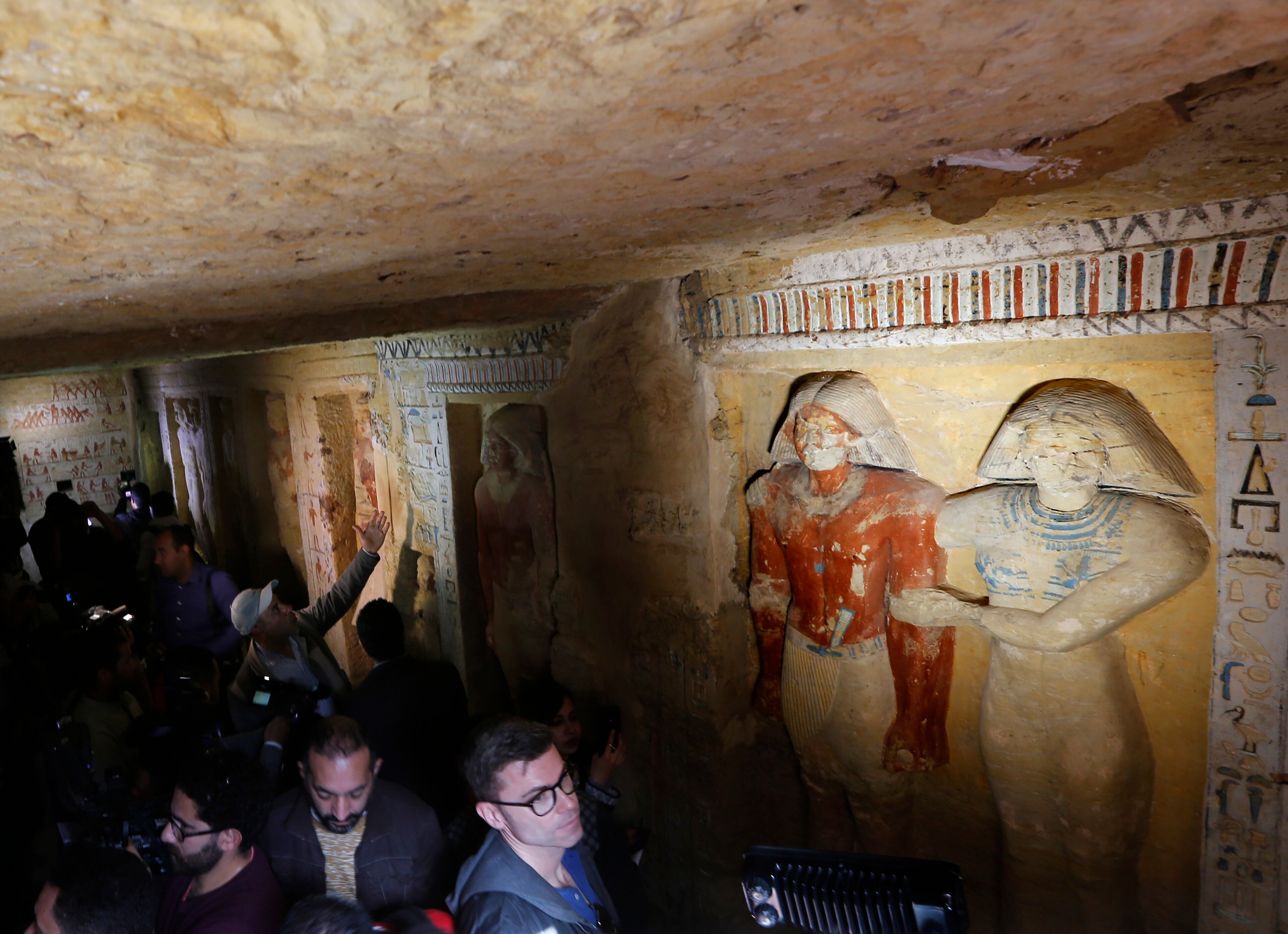Cameramen and visitors visit the recently uncovered tomb of the Priest royal Purification during the reign of King Nefer Ir-Ka-Re, named "Wahtye", at the site of the step pyramid of Saqqara, in Giza, Egypt, Saturday, Dec. 15, 2018. The Egyptian Archaeological Mission working at the Sacred Animal Necropolis in Saqqara archaeological site succeeded to uncover the tomb, Antiquities Minister Khaled el-Anani, announced.(AP Photo/Amr Nabil)