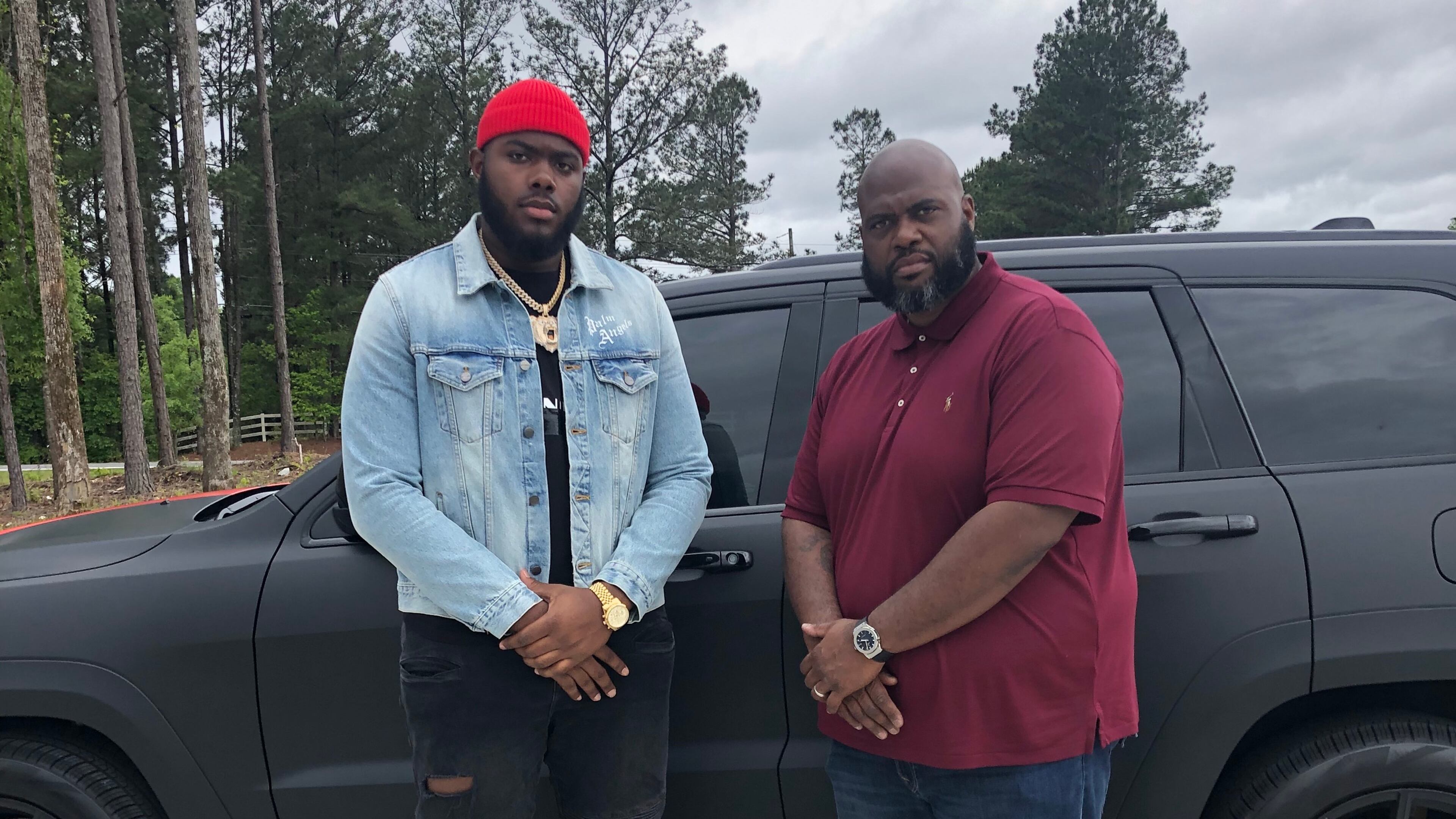 Georgia offensive tackle Andrew Thomas (L) poses with Kevin Johnson, his position coach at Pace Academy, in the driveway of Johnson's Fayetteville home Thursday. There, pupil and coach were taking in the first round of the NFL draft. (Special photo)